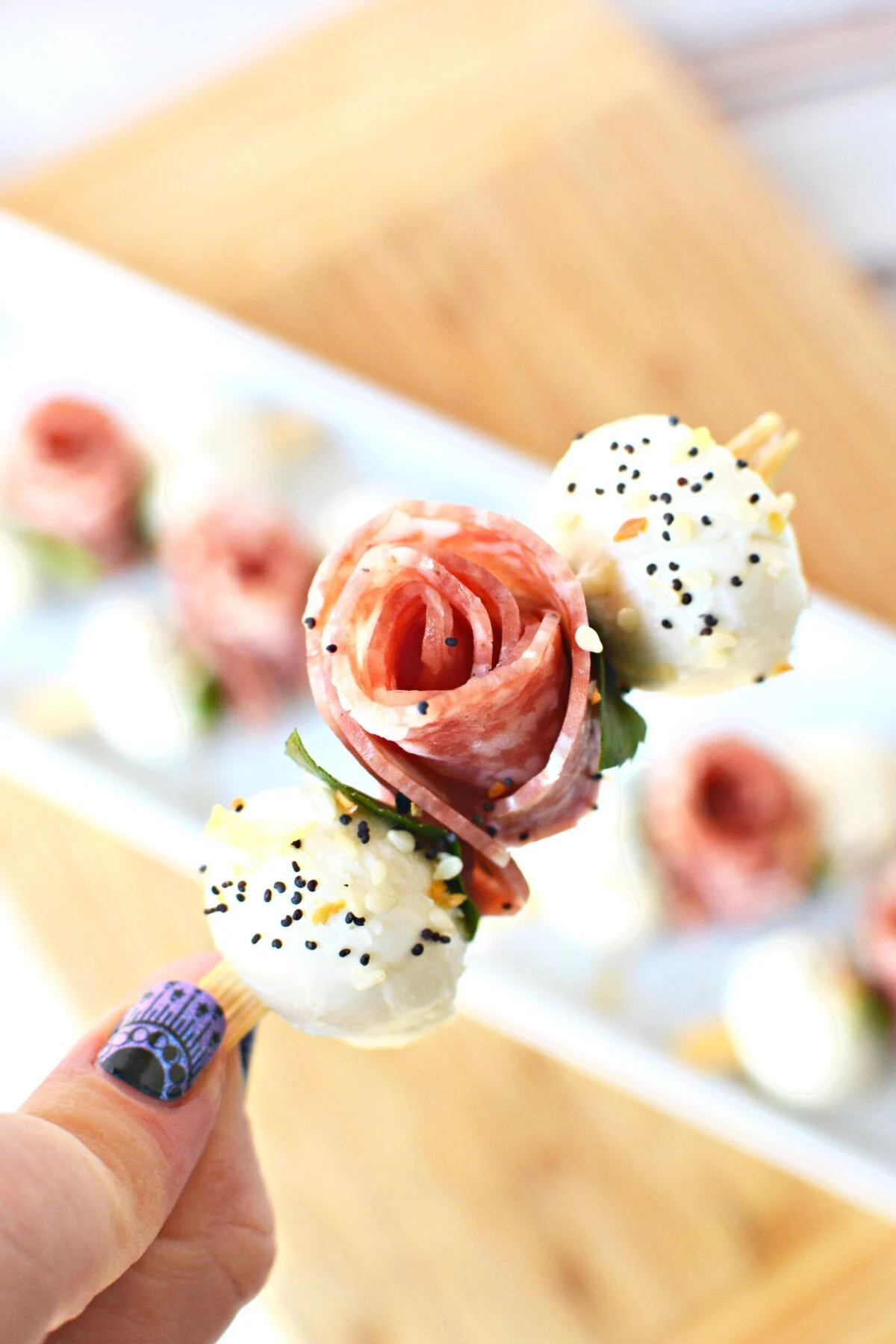 skewers with little mozzarella balls and salami roses.