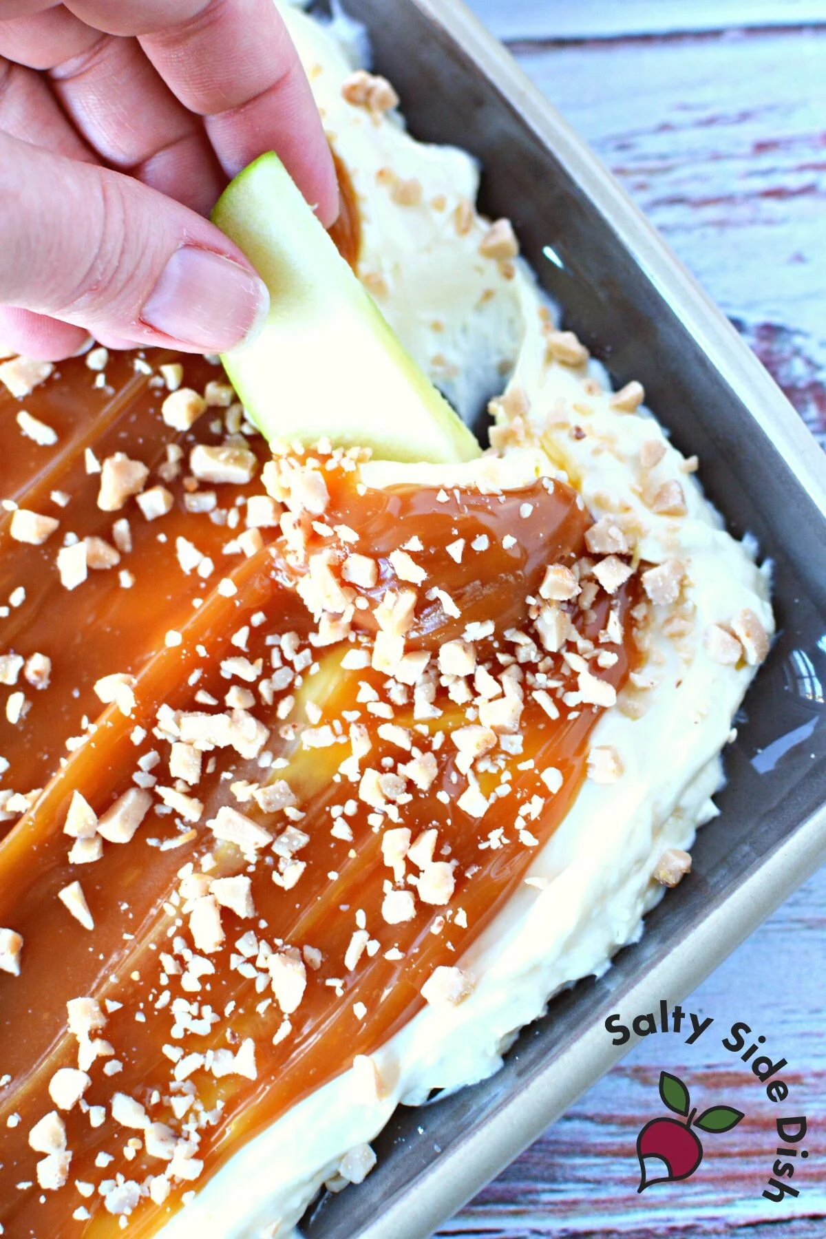 slice of apple dipping in cheesecake dip.
