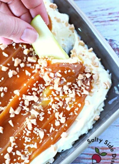 slice of apple dipping in cheesecake dip.