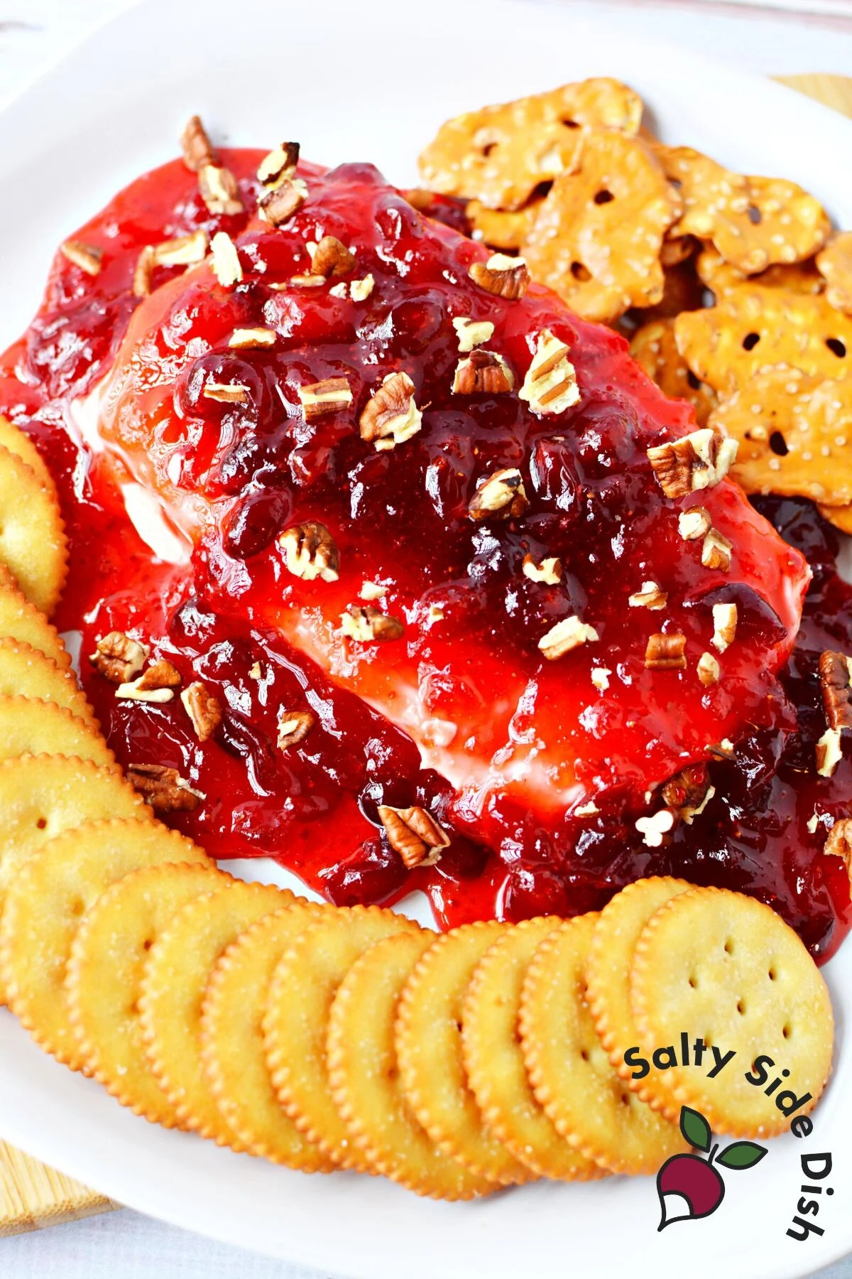 smothered cream cheese brick with strawberry and cranberry preserves.