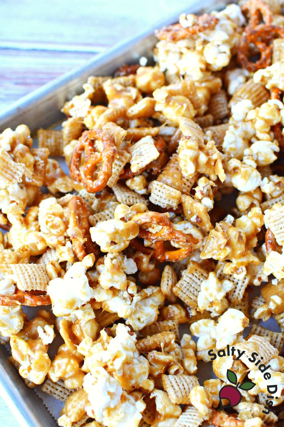 popcorn chex mix with homemade caramel sauce going into the oven.