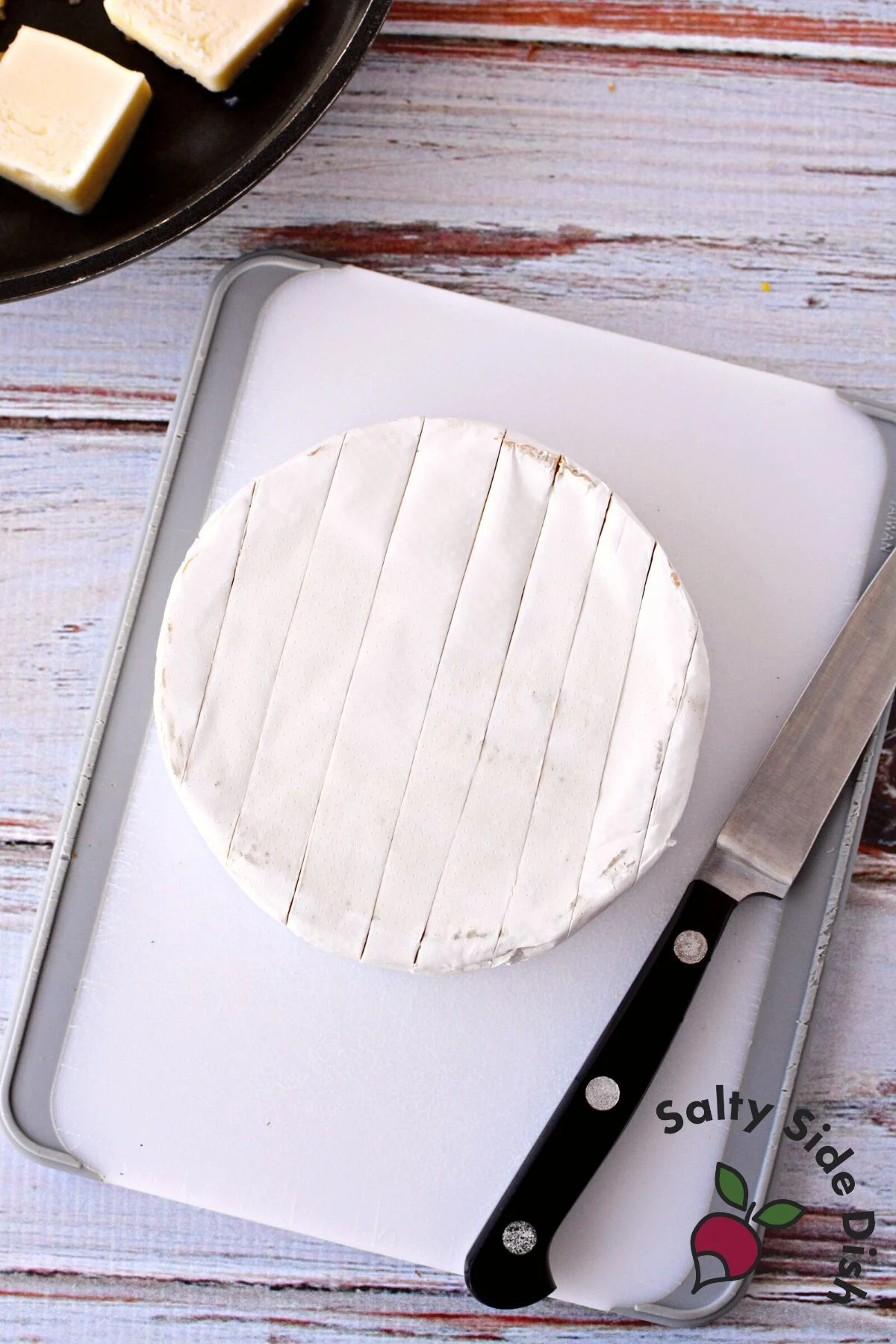 slicing open brie cheese.