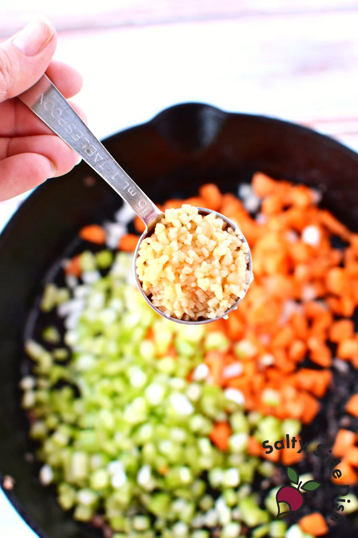 chopped vegetables in a cast iron pan.