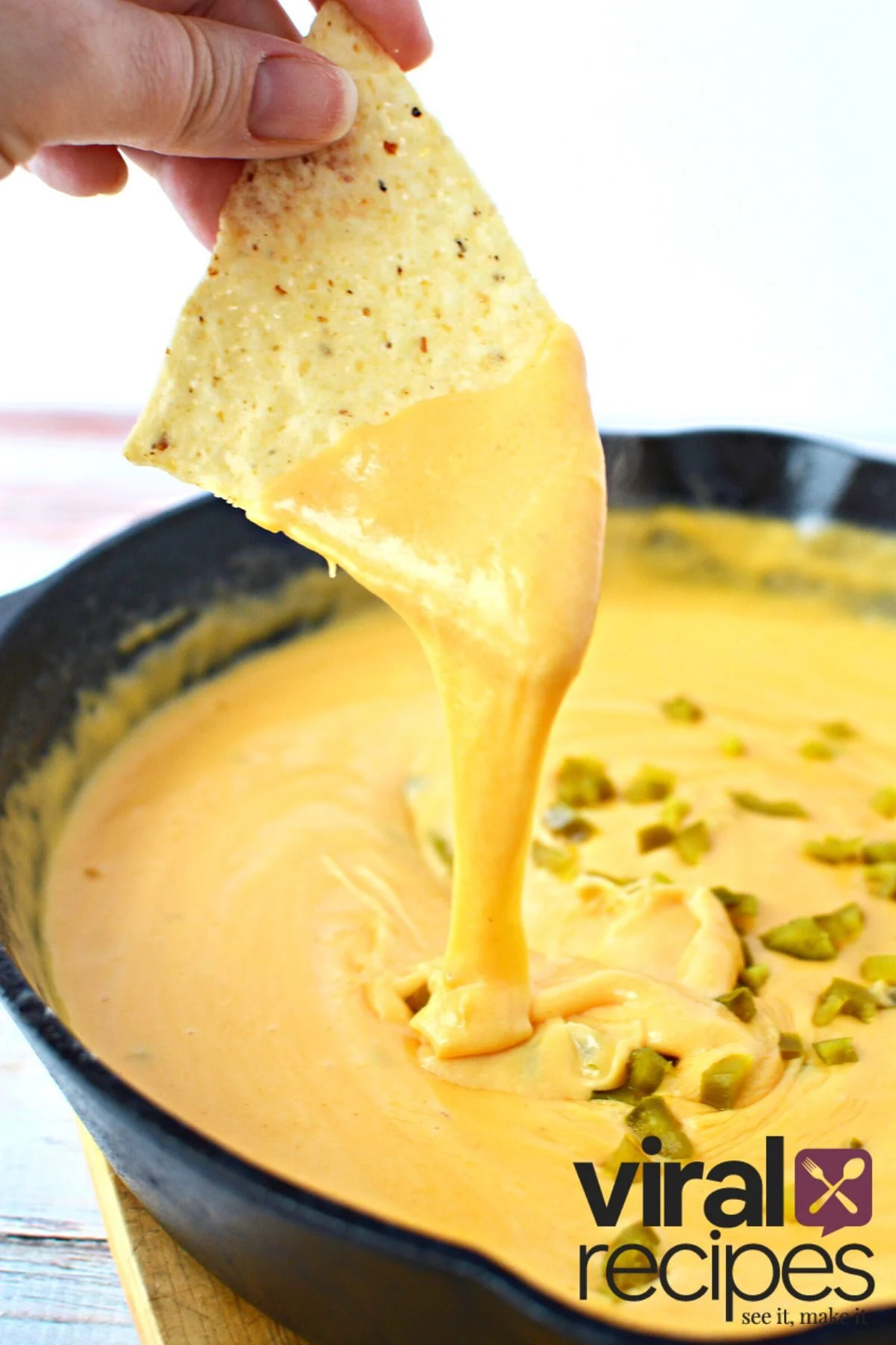 nacho cheese dip recipe in a cast iron pan.