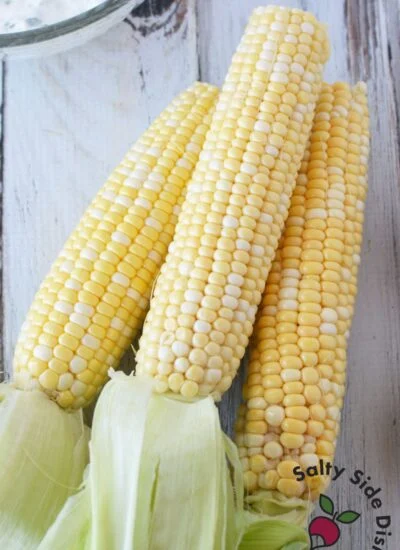 3 ears of corn on the cob with the husks pulled back.