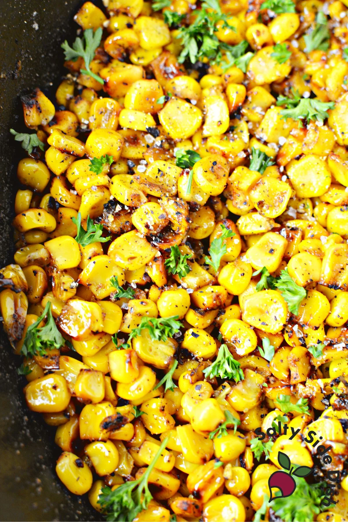 close up of charred corn in a deep dish skillet.