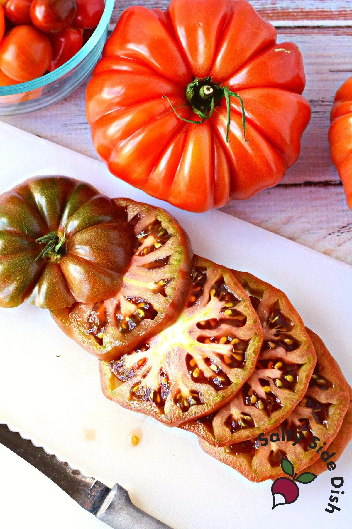 sliced tomatoes on a cutting board.
