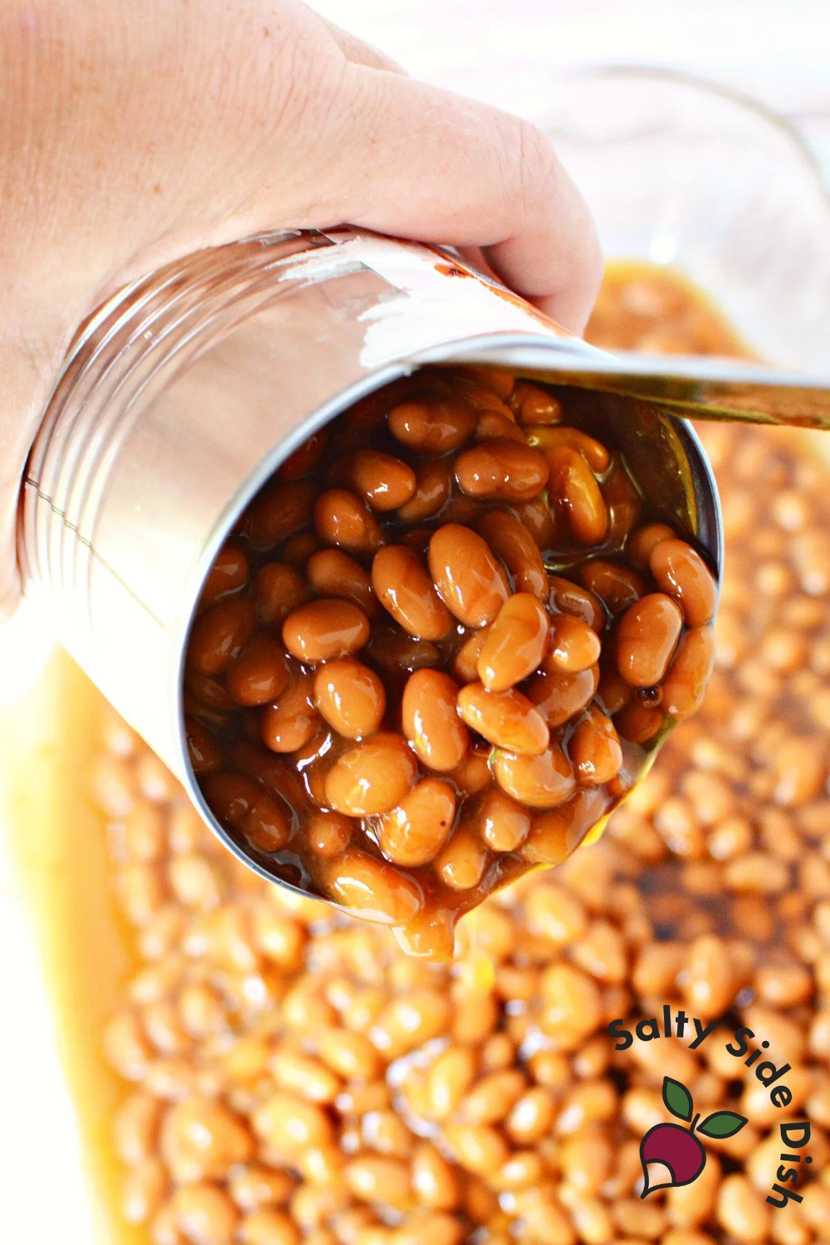pouring canned beans from a can.
