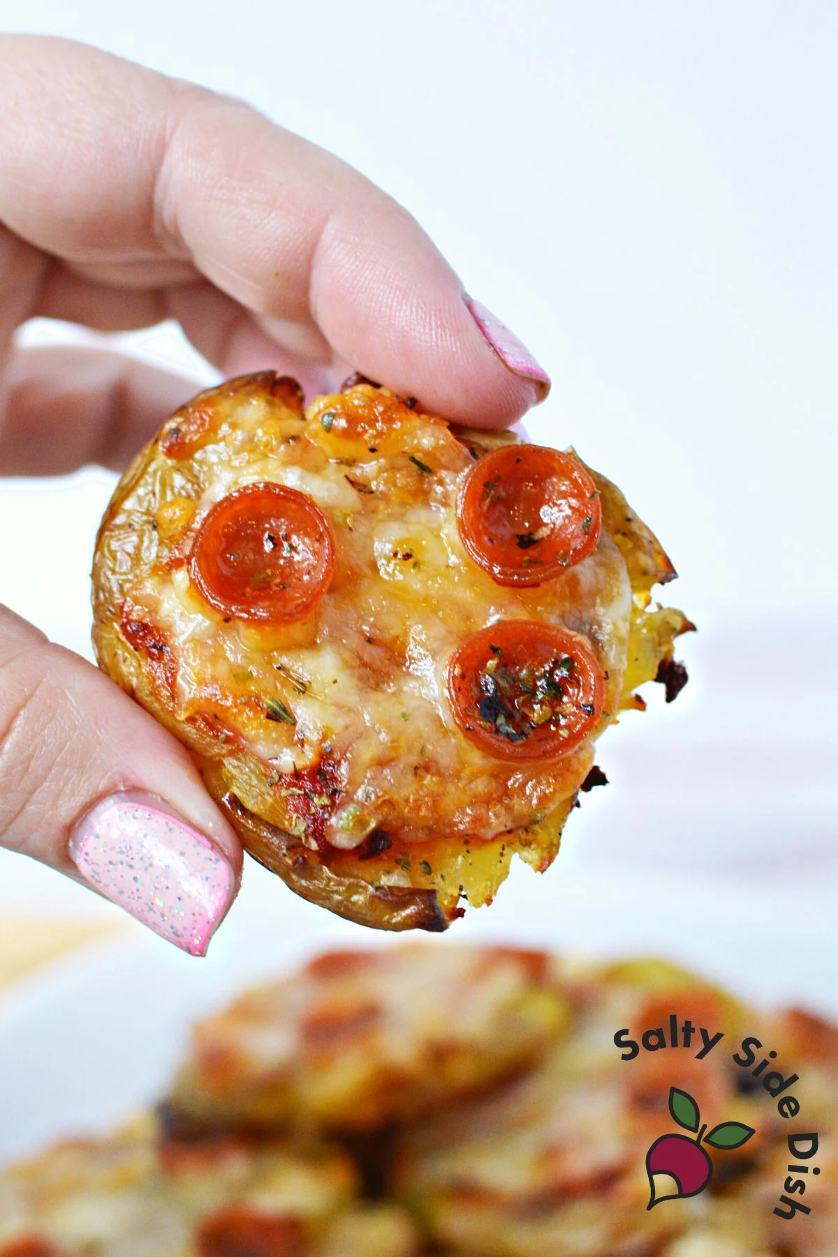 holding a viral mini potato pizza.