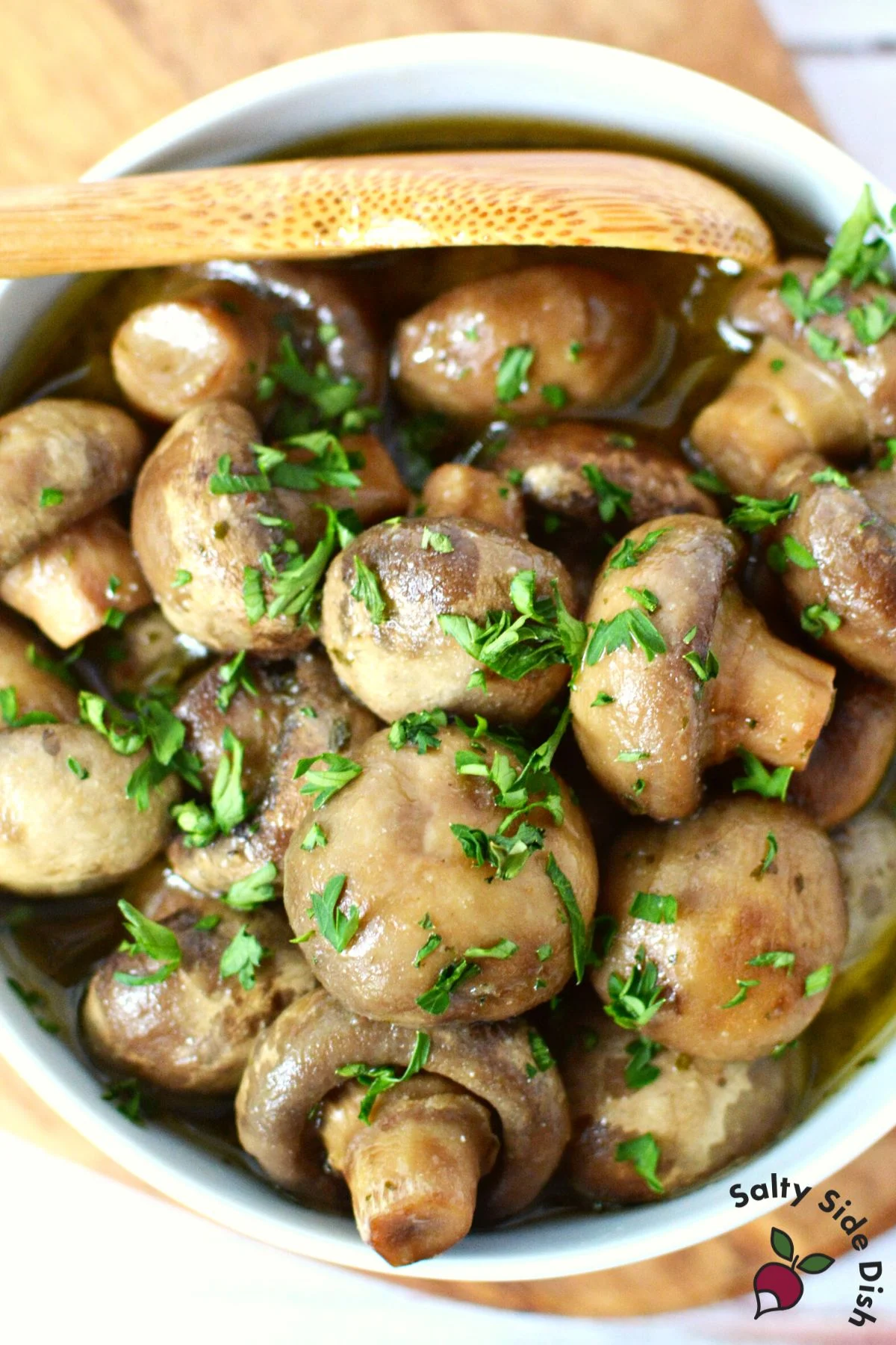 large white bowl serving up mushrooms for an appetizer dish.