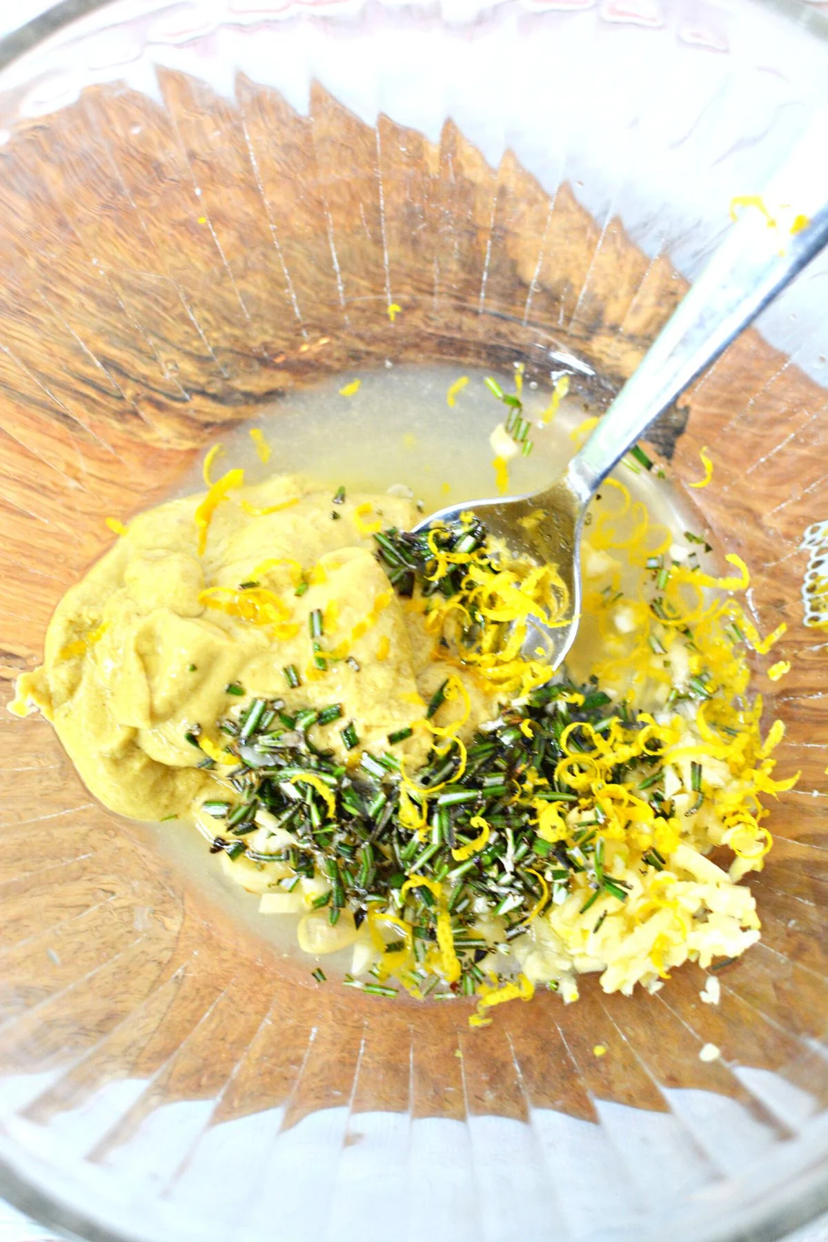 making marinade in a bowl with lemon.