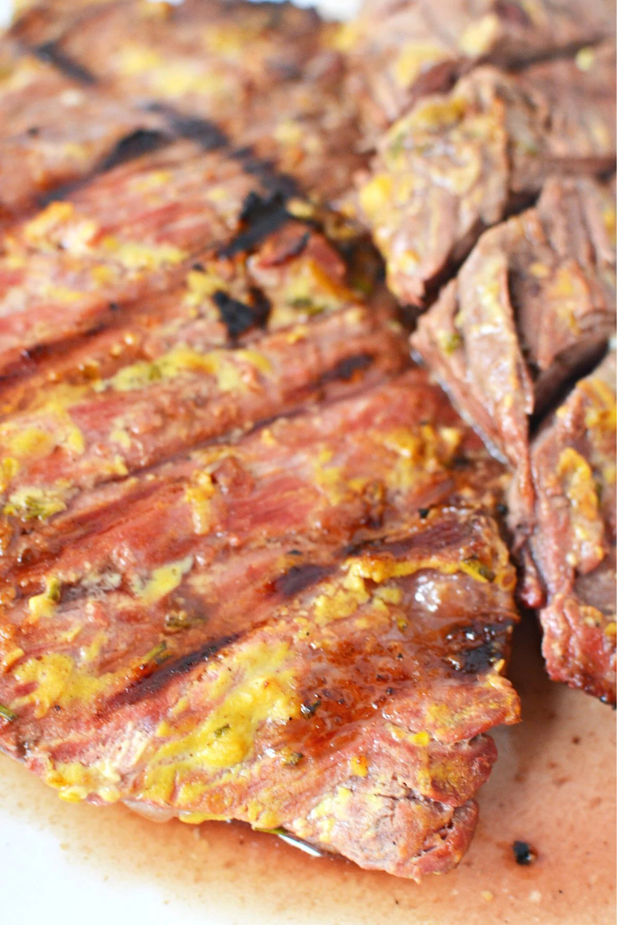 skirt steak on a white platter