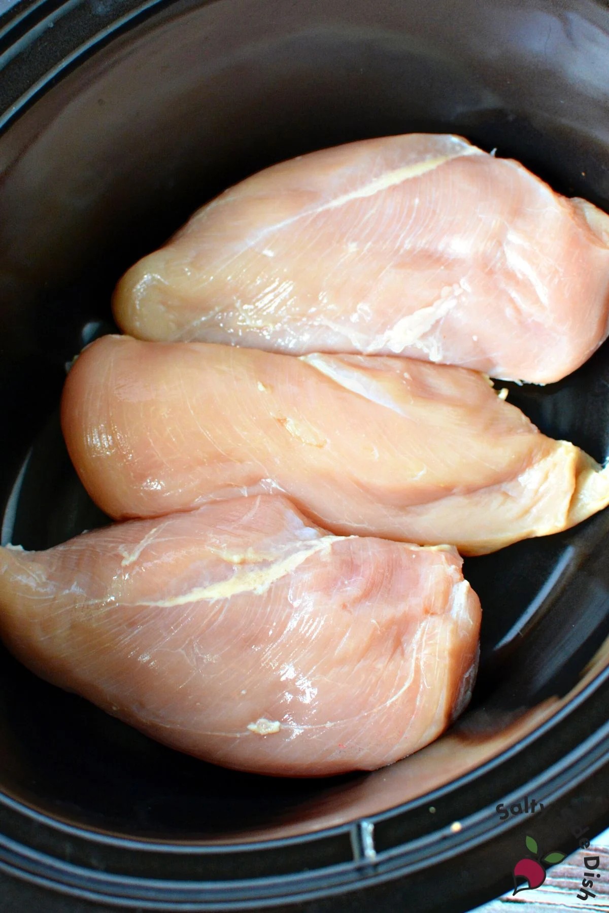 boneless chicken breasts in a crockpot.