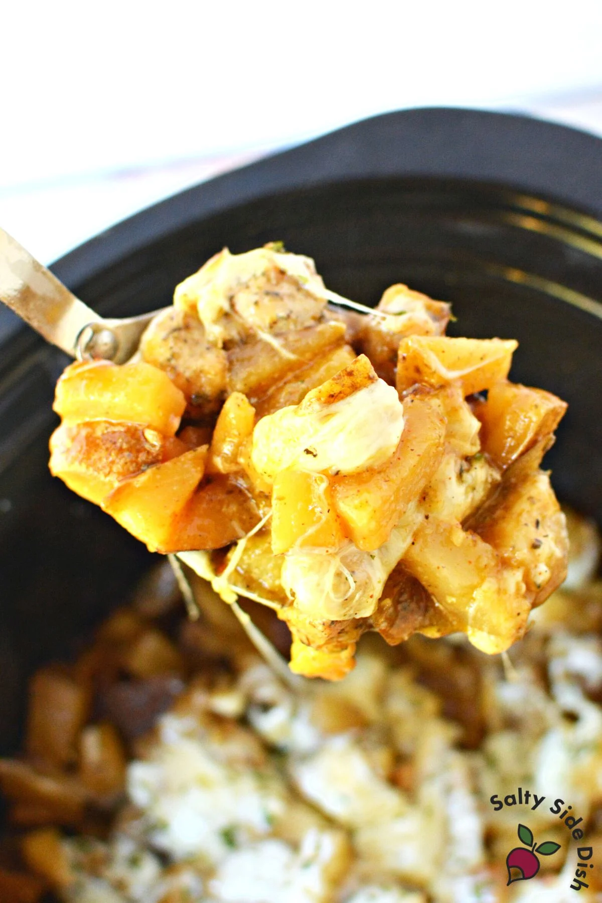 potatoes, chicken and cheese on a spoon.