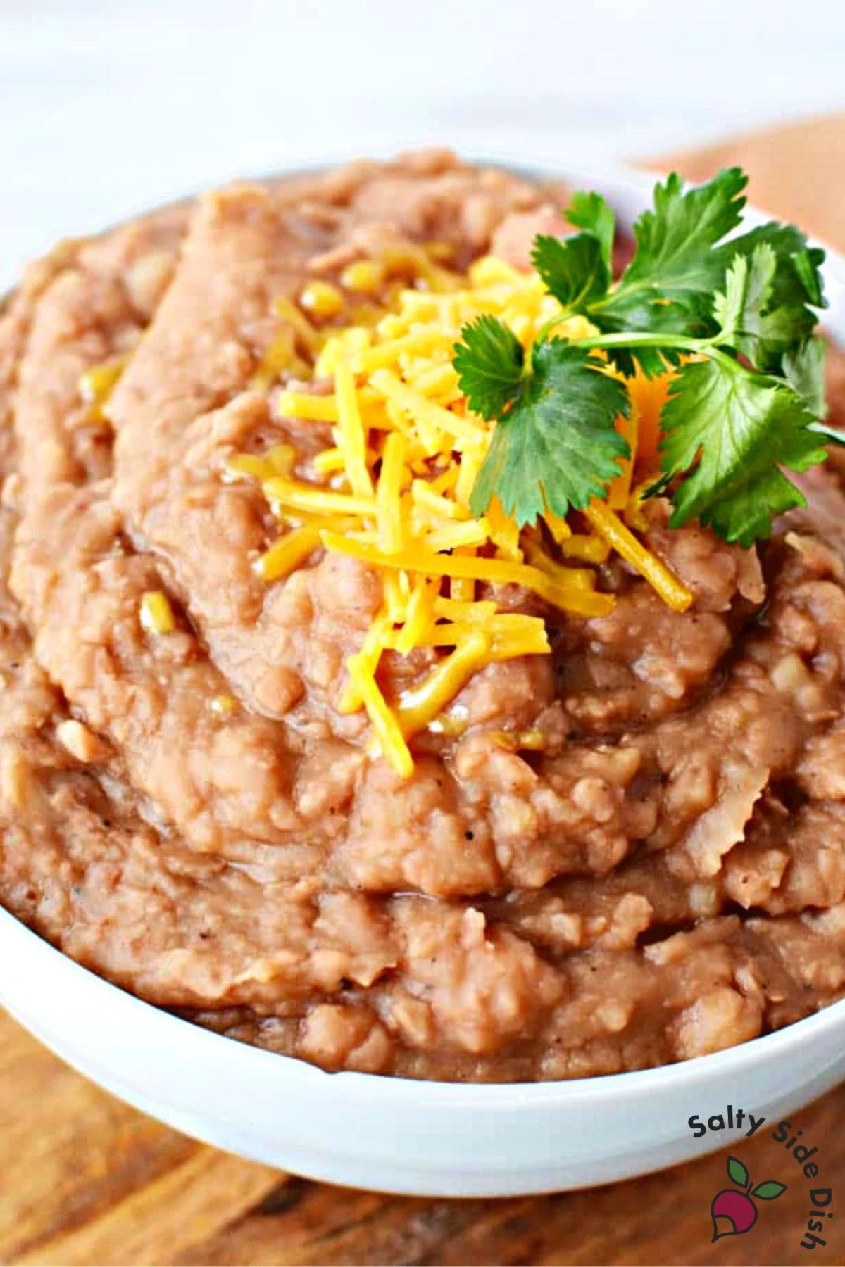 refried beans in a white bowl.