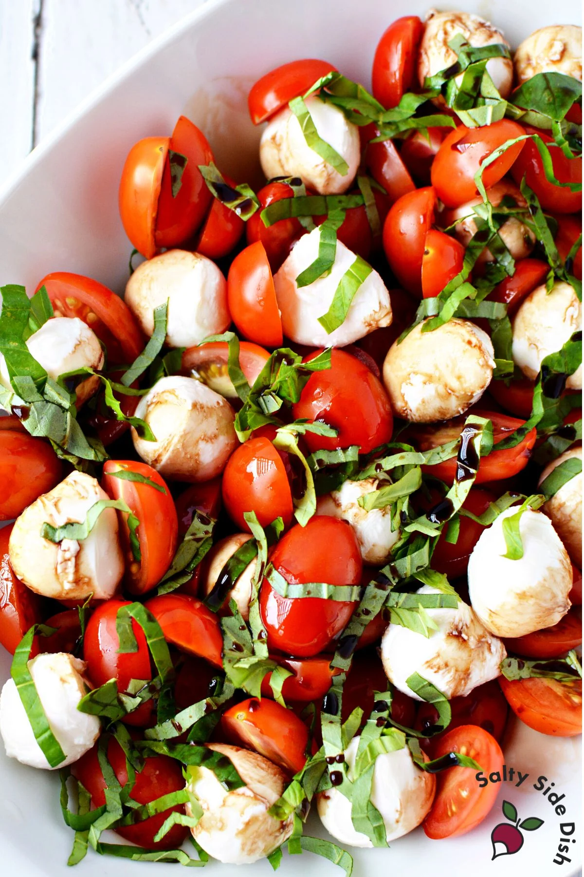caprese salad in a white dish.