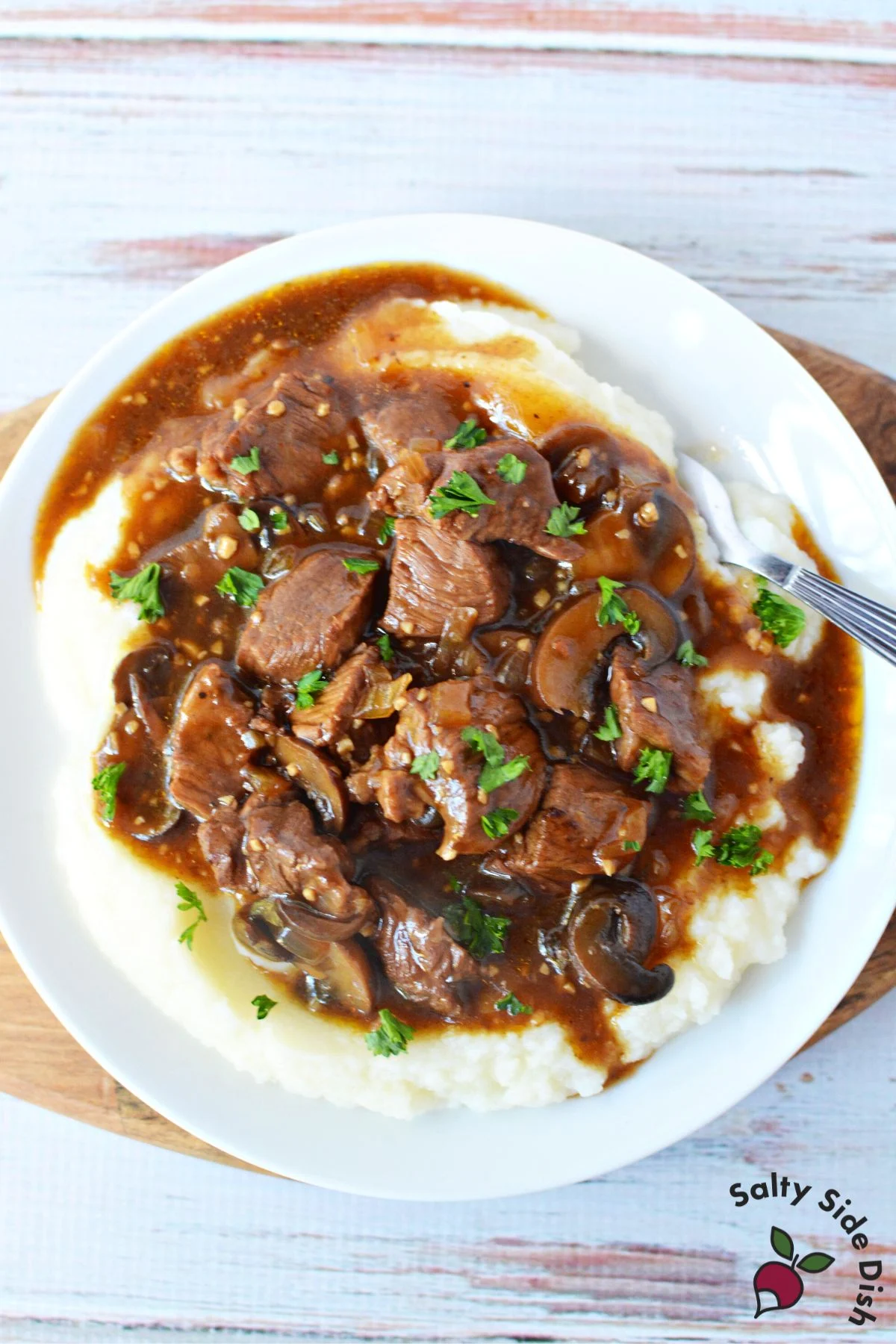 beef short ribs or sirloin tip in crockpot over mashed potatoes.