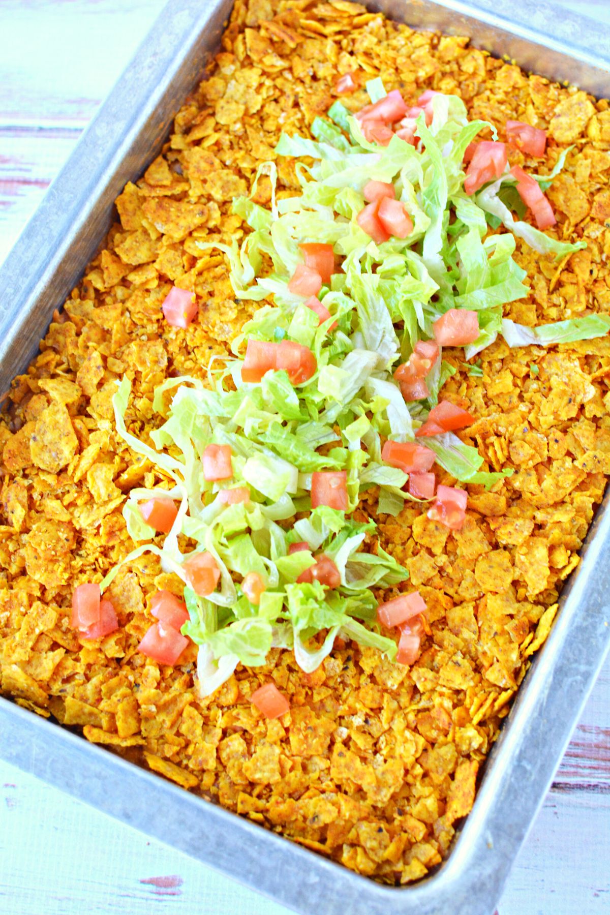 pan full of Doritos casserole with topping.