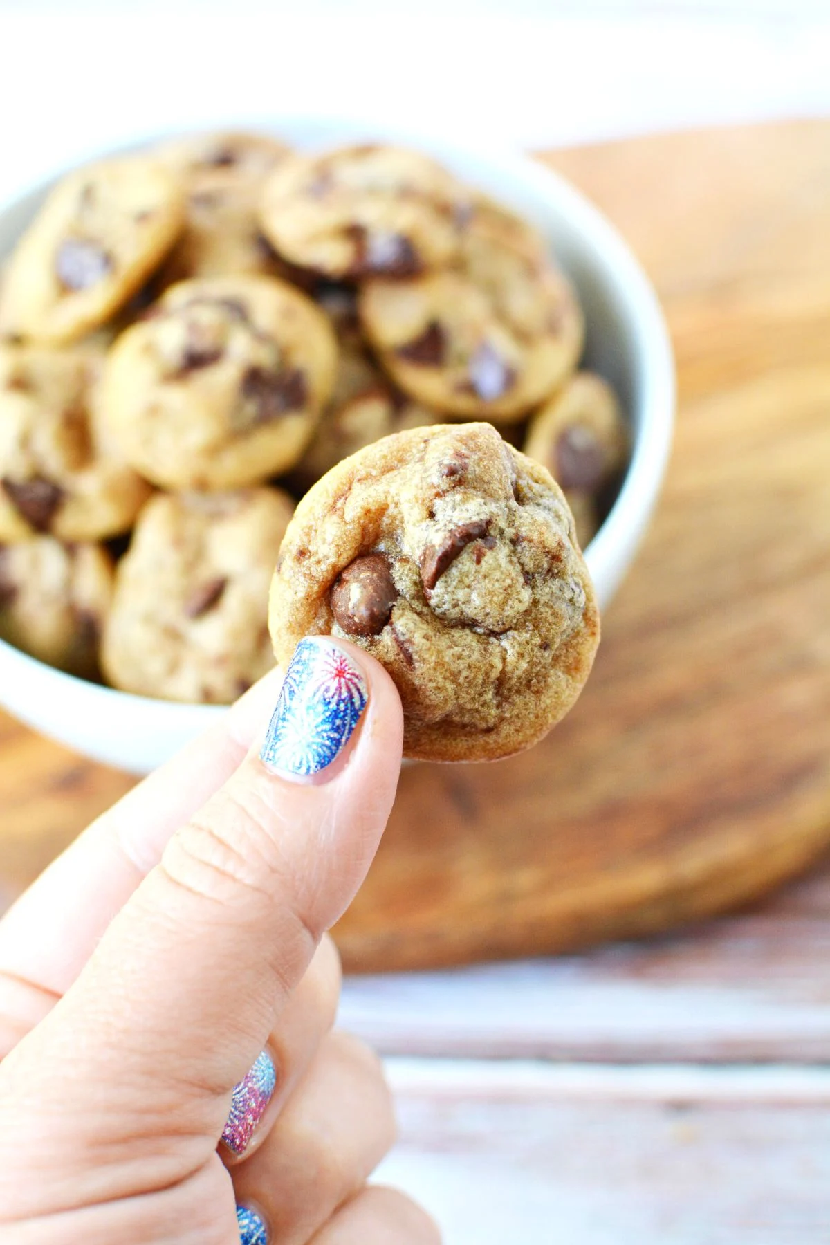 mini chocolate chip cookies being held.