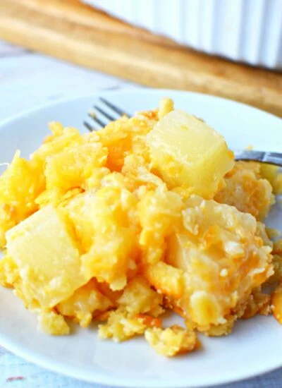 chunky pineapple on a plate with fork.