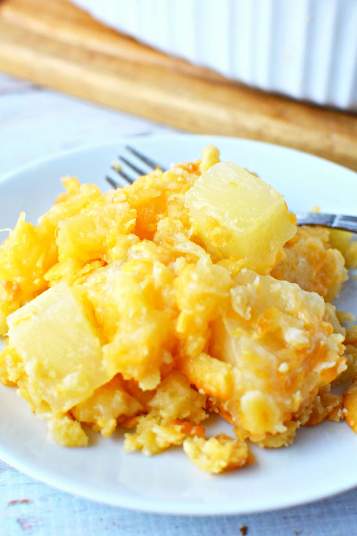 chunky pineapple on a plate with fork.