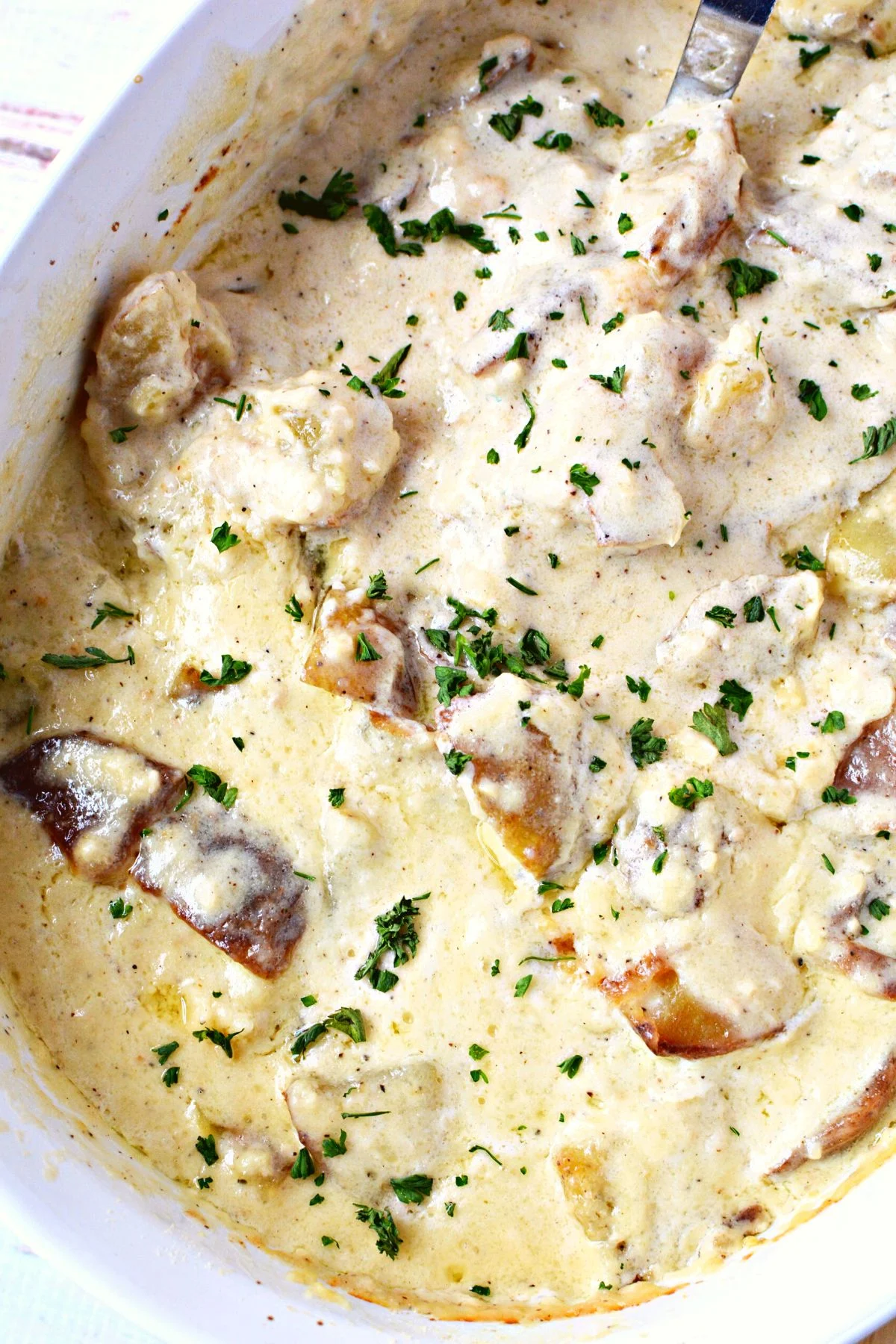 creamy alfredo potatoes in a casserole dish.