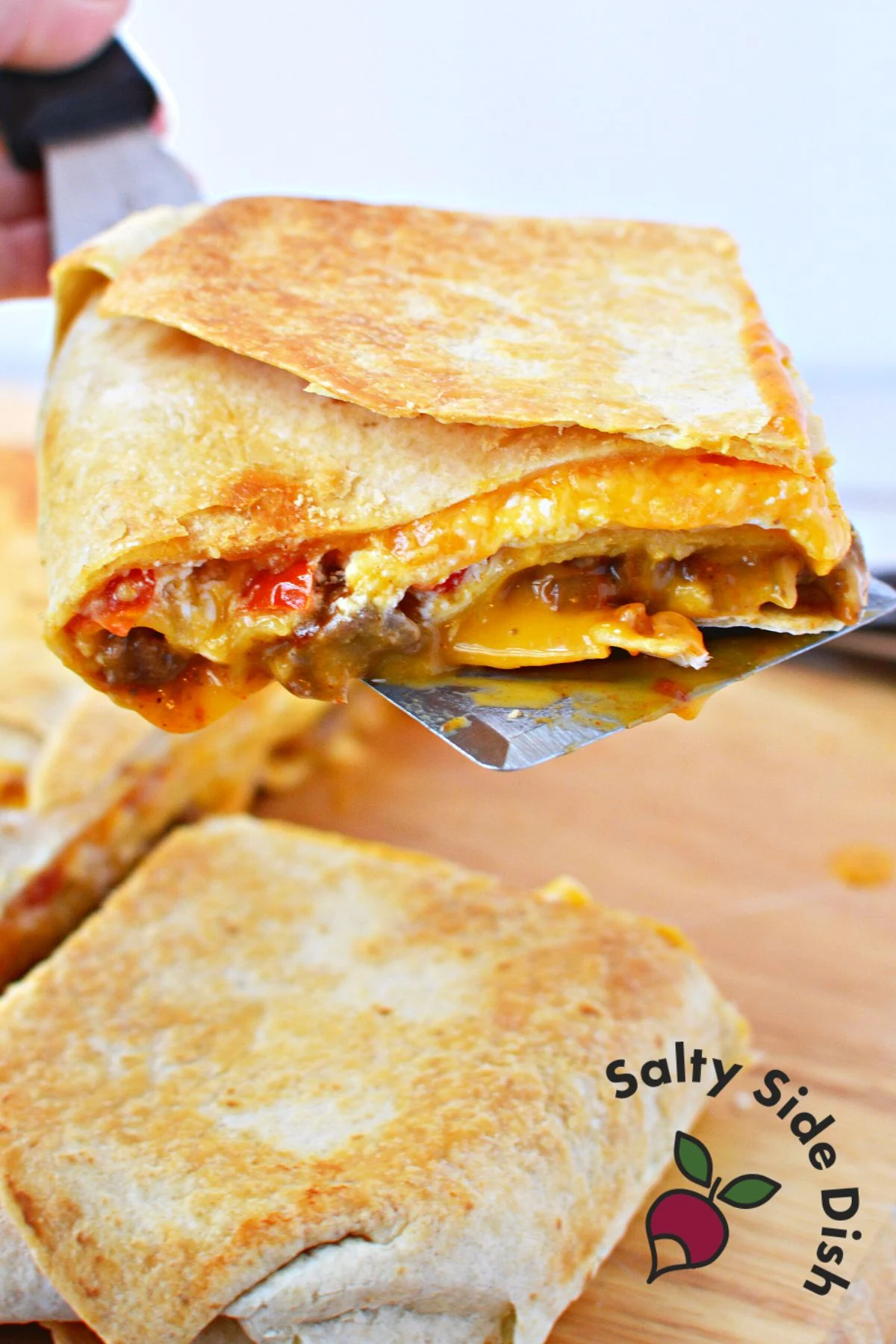 serving crunchwrap casserole on a spatula.
