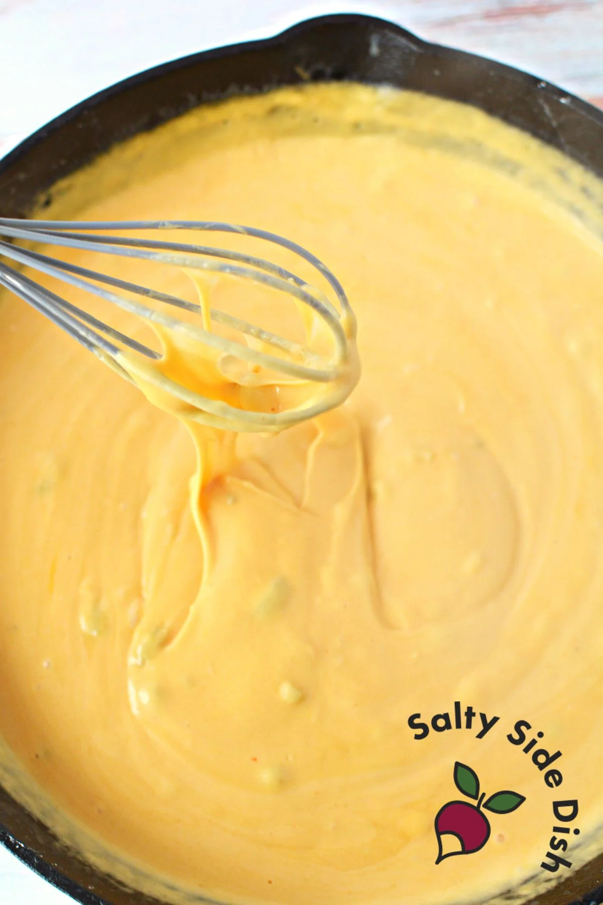 stirring homemade cheese dip