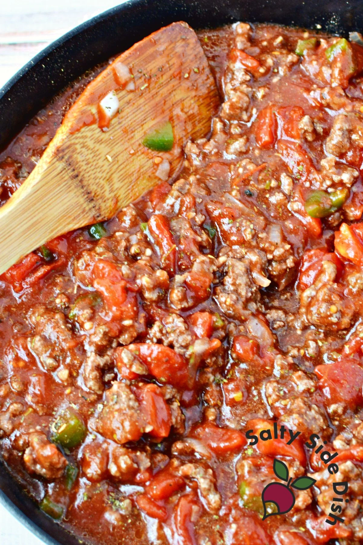 stirring up ingredients with a wooden spoon.