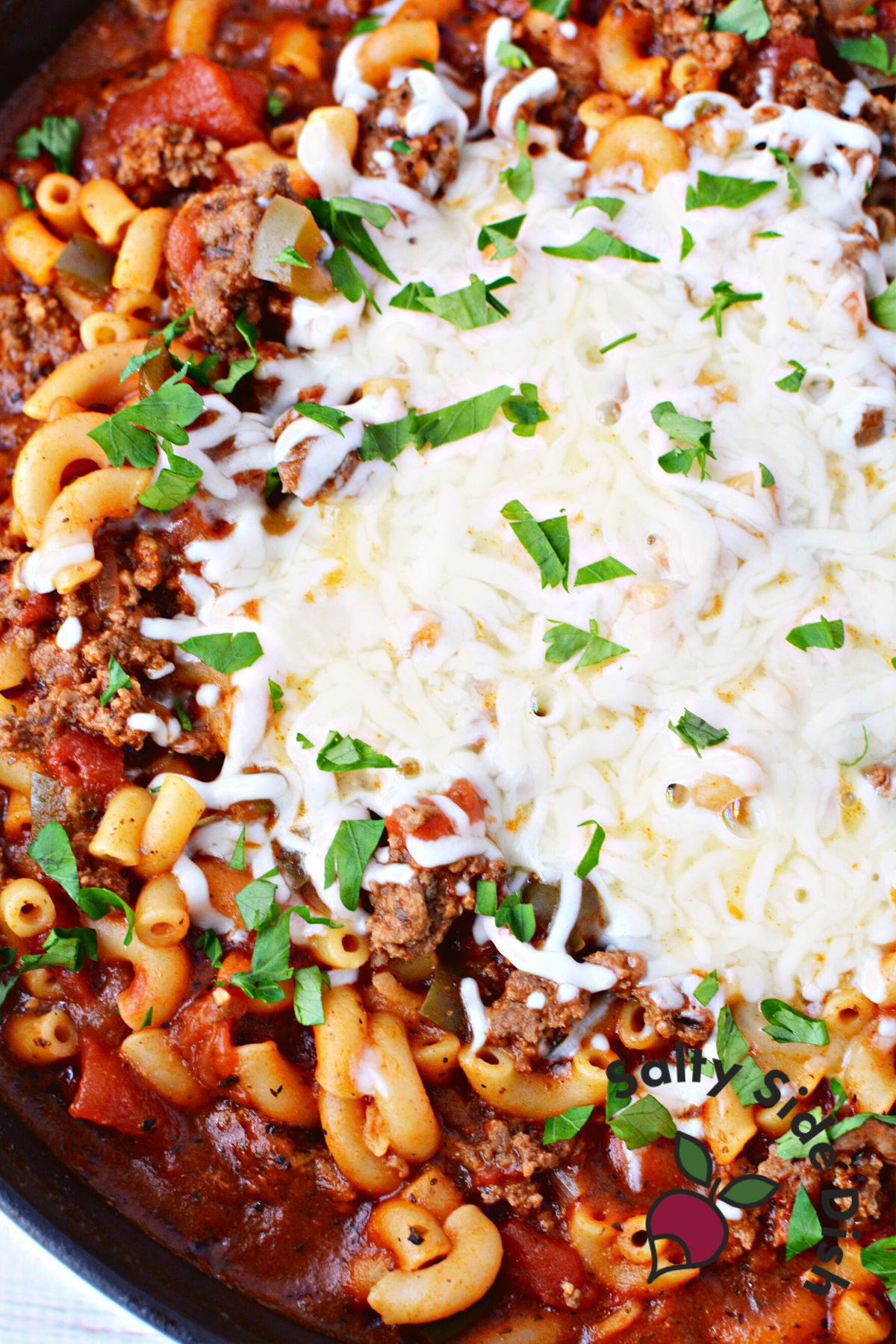 melted mozzarella cheese on top of beefaroni.