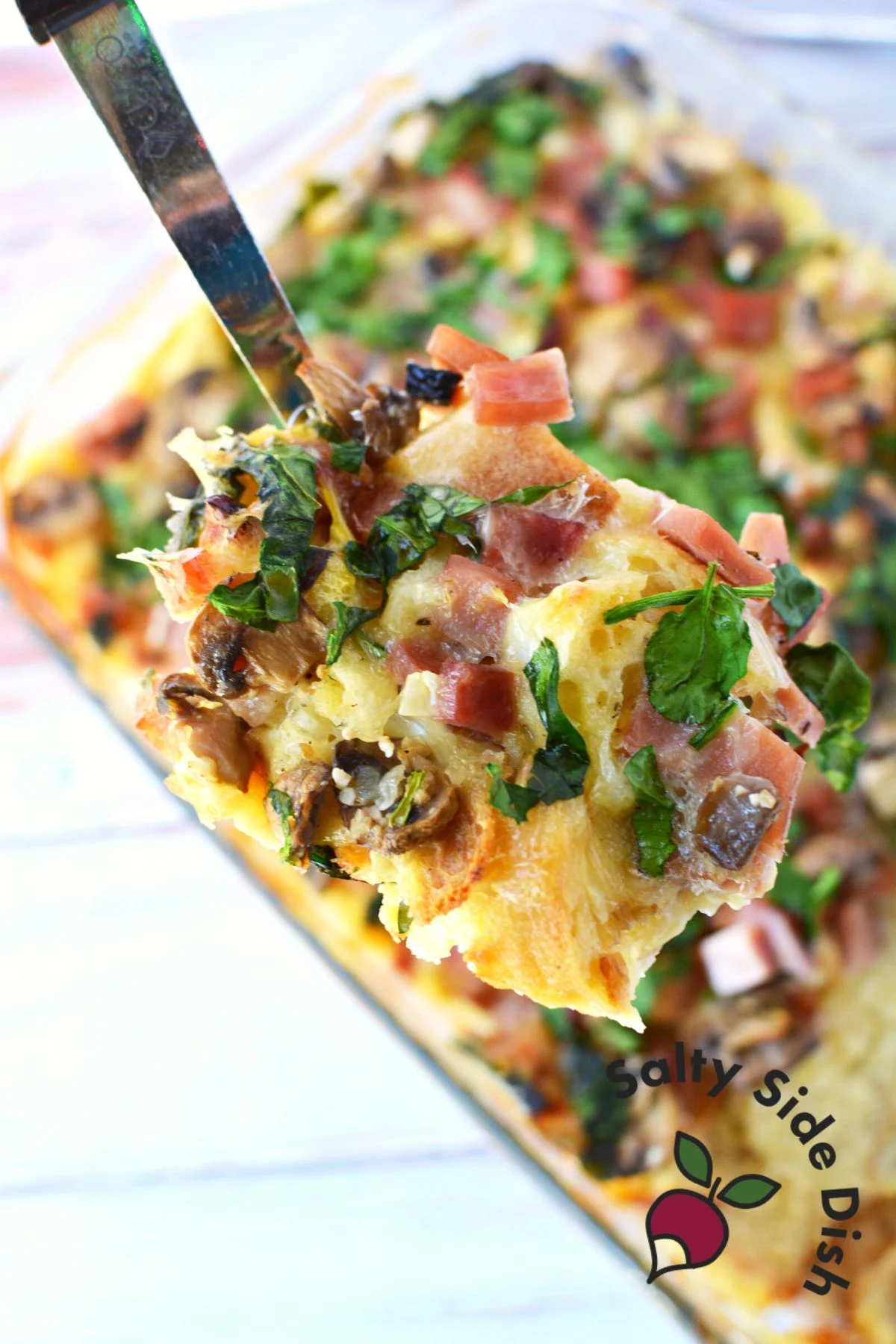 scoop of cheese and ham strata.
