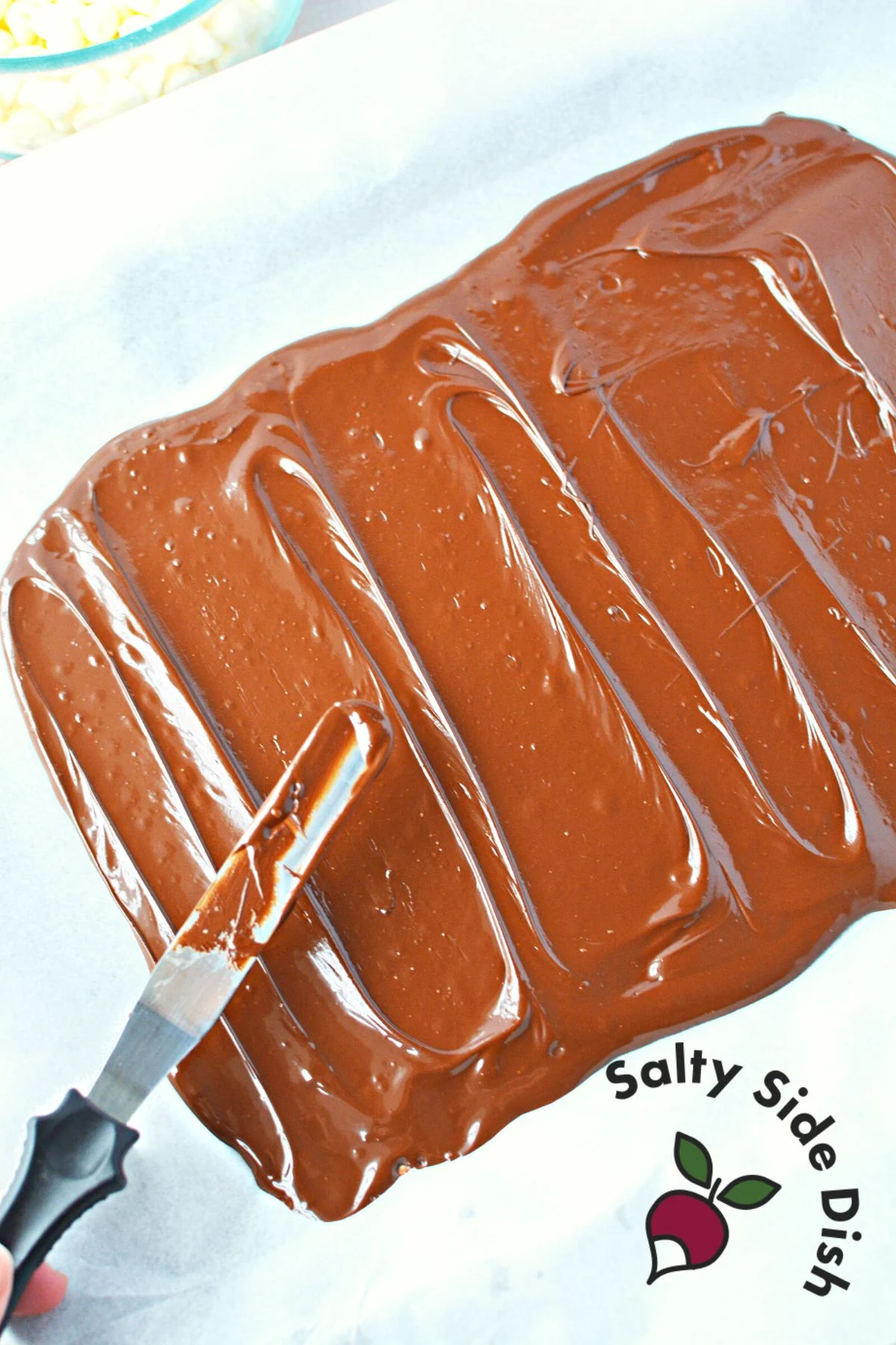 spread chocolate layer with a knife or spatula on a parchment paper.