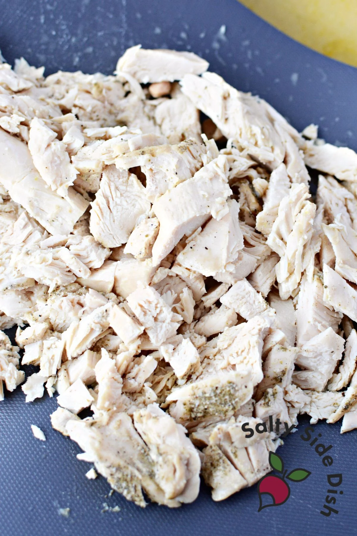 chopped up chicken on a cutting board.