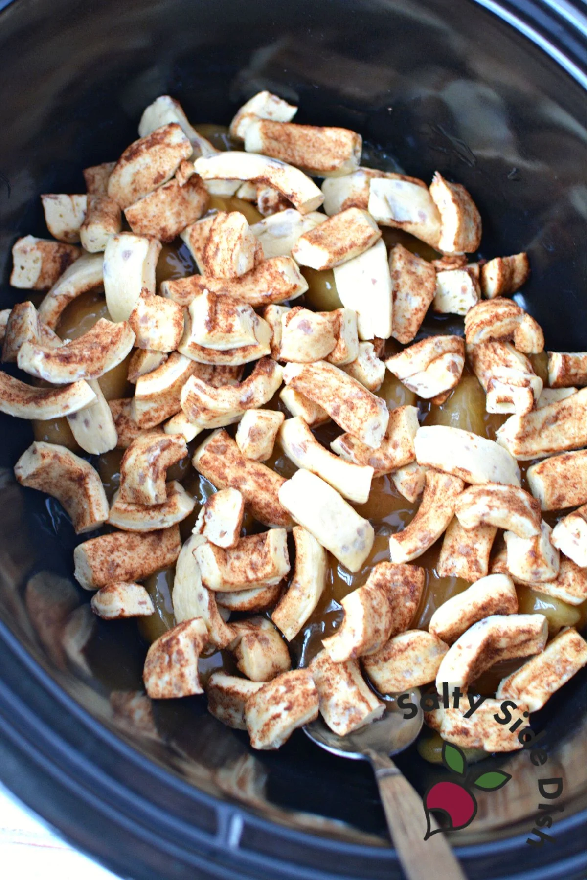 broken down and cut cinnamon rolls into bottom of the slow cooker pan.