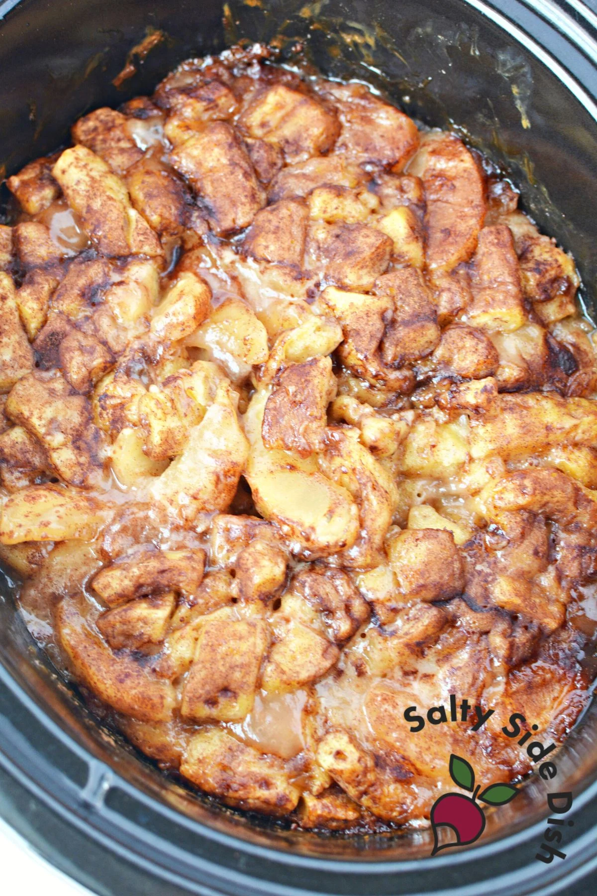 cinnamon rolls in crockpot that are cooked and ready to eat.