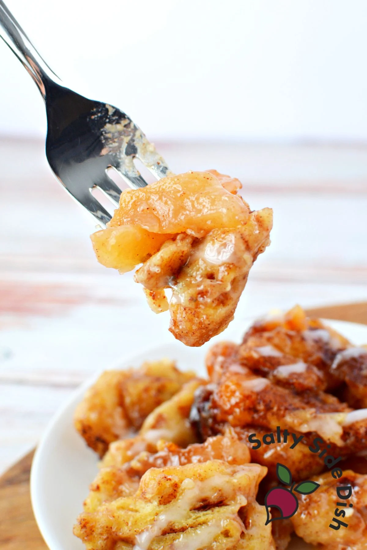 apple pie filling and cinnamon rolls on a fork.