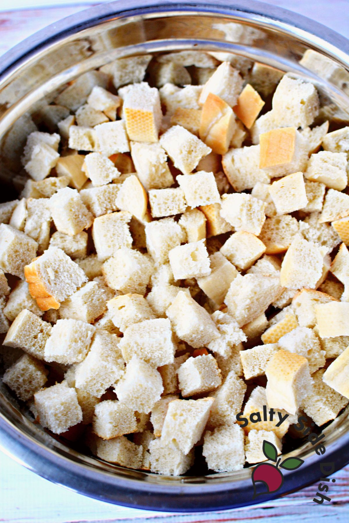 cubed french bread in a mixing bowl.
