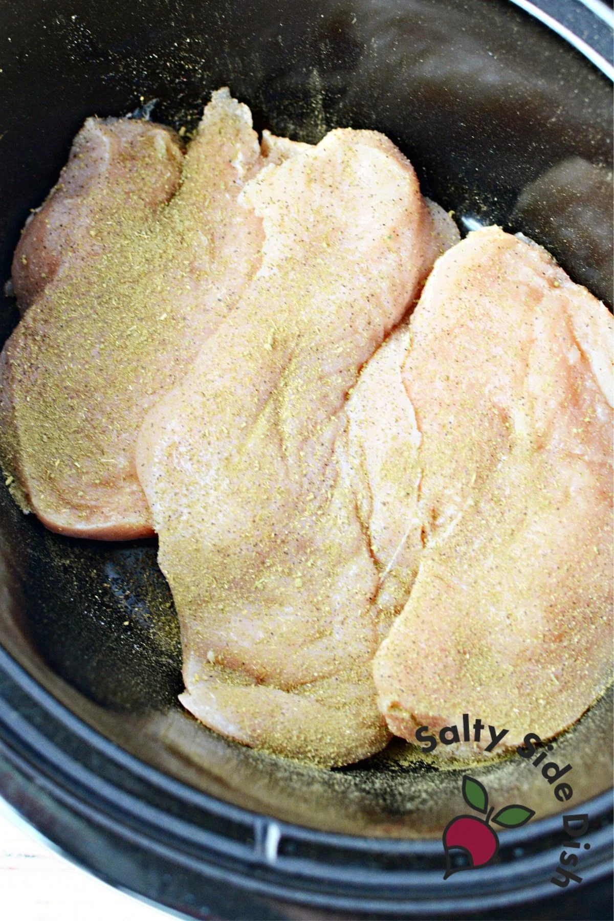 add seasoning to chicken breasts.