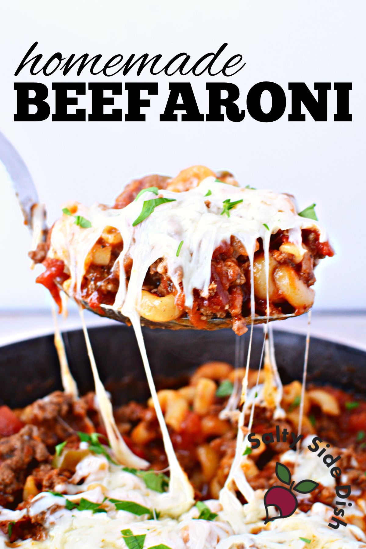spoon with beefaroni and cheese with the title homemade beefaroni.