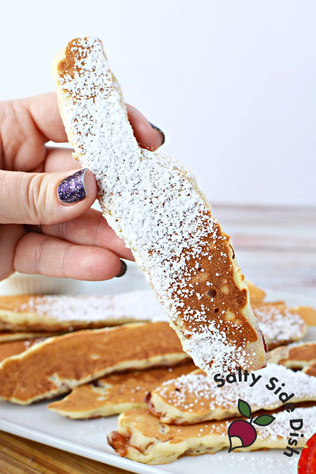 holding a pancake dipper.