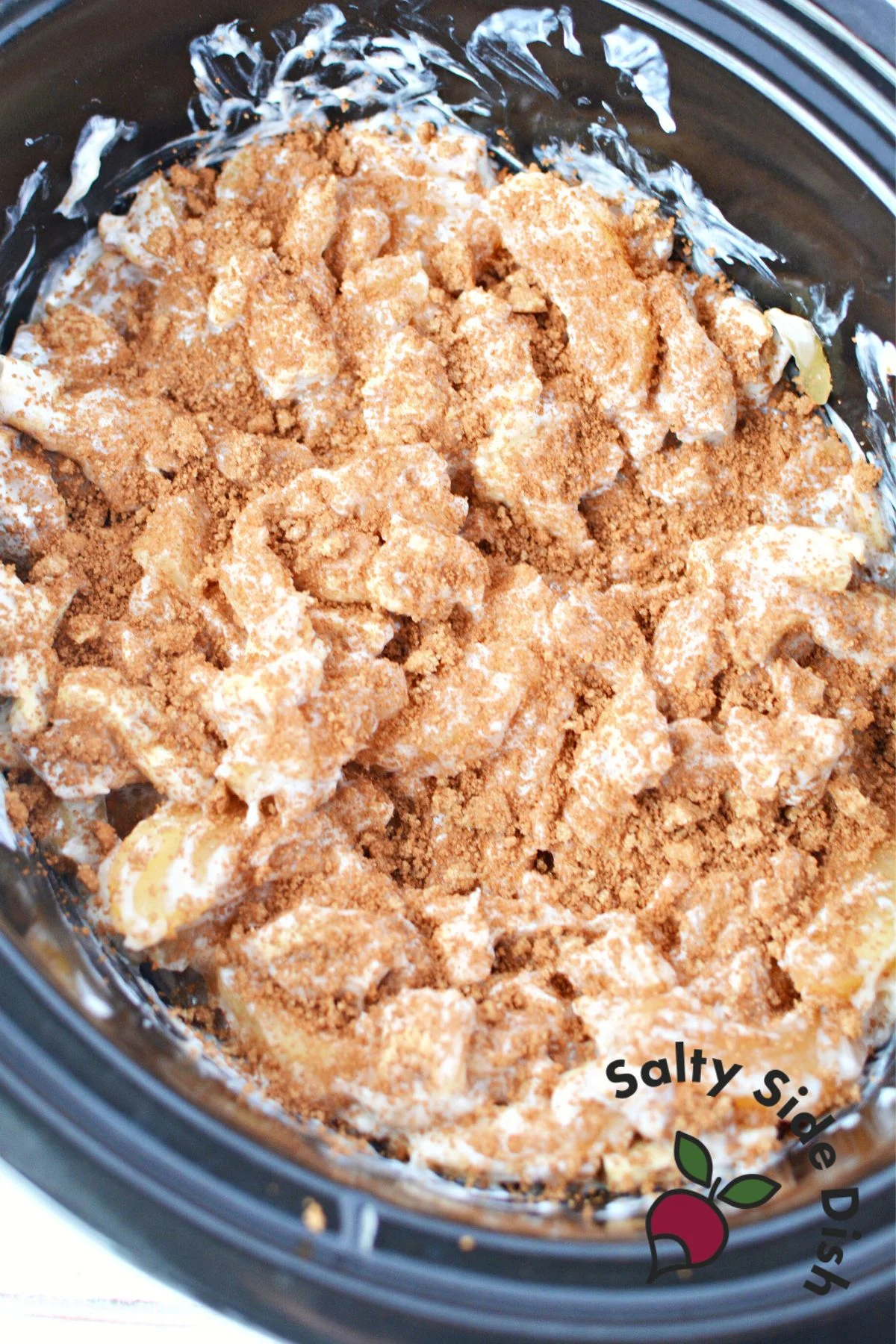cinnamon sugar over top of cinnamon rolls in slow cooker and not cooked yet.