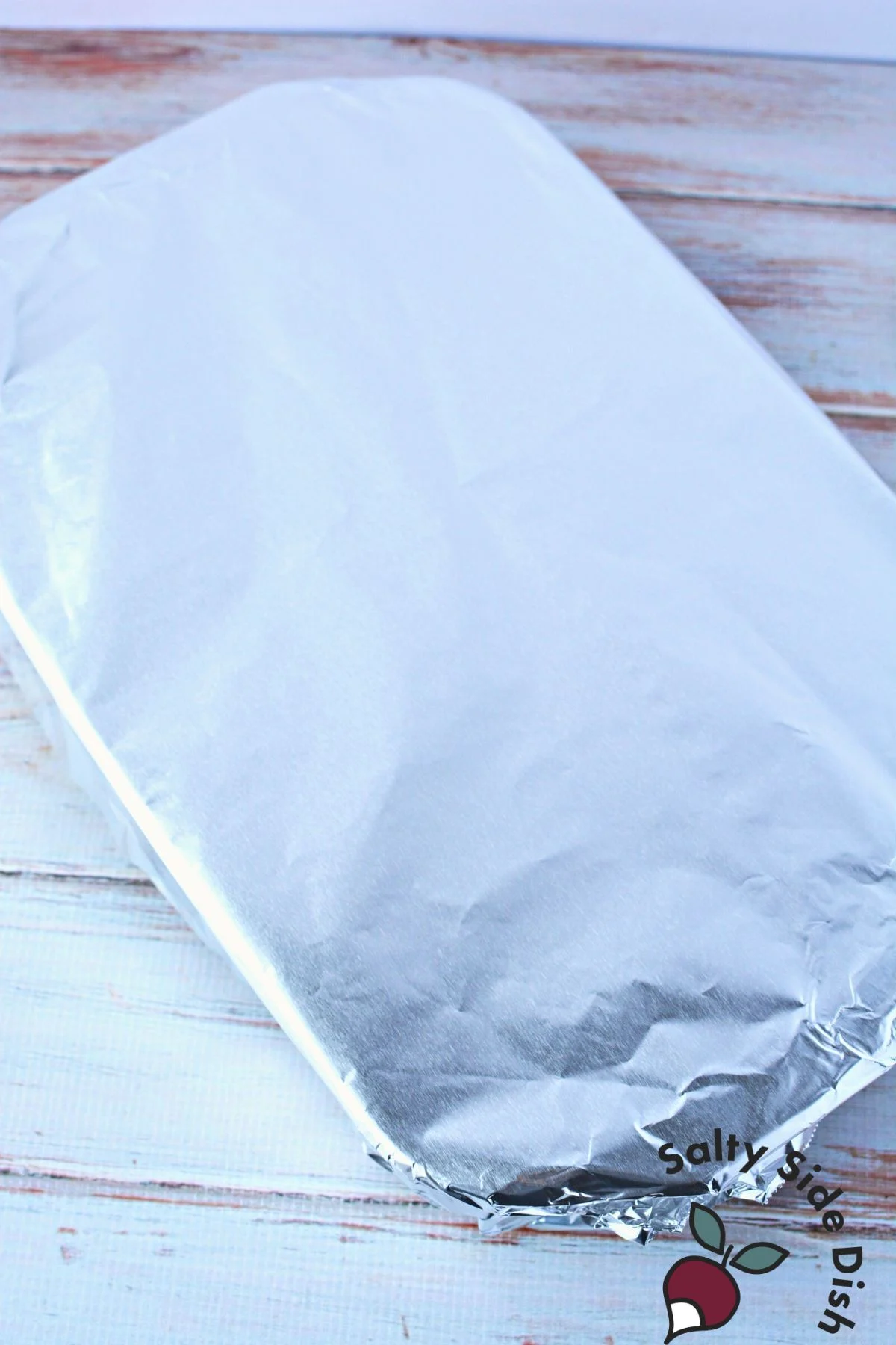 adding aluminum foil to baking dish.