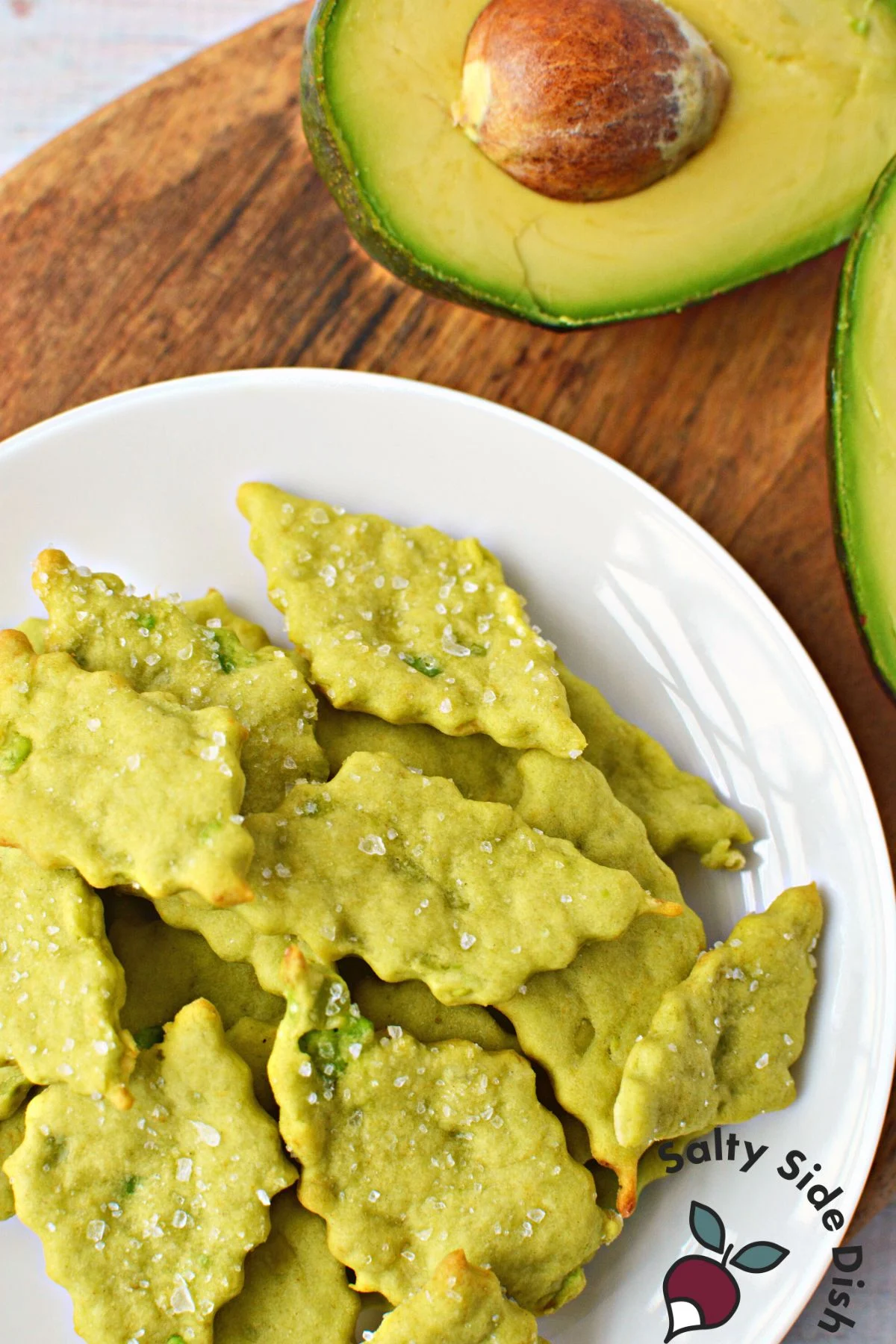 oven baked avocado crackers on a white plate.