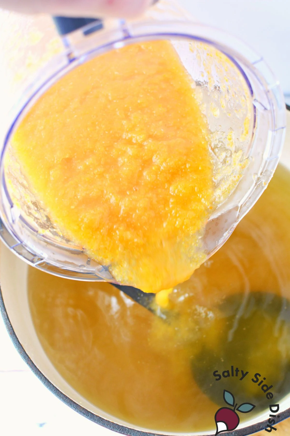 pouring blended vegetables back into broth.