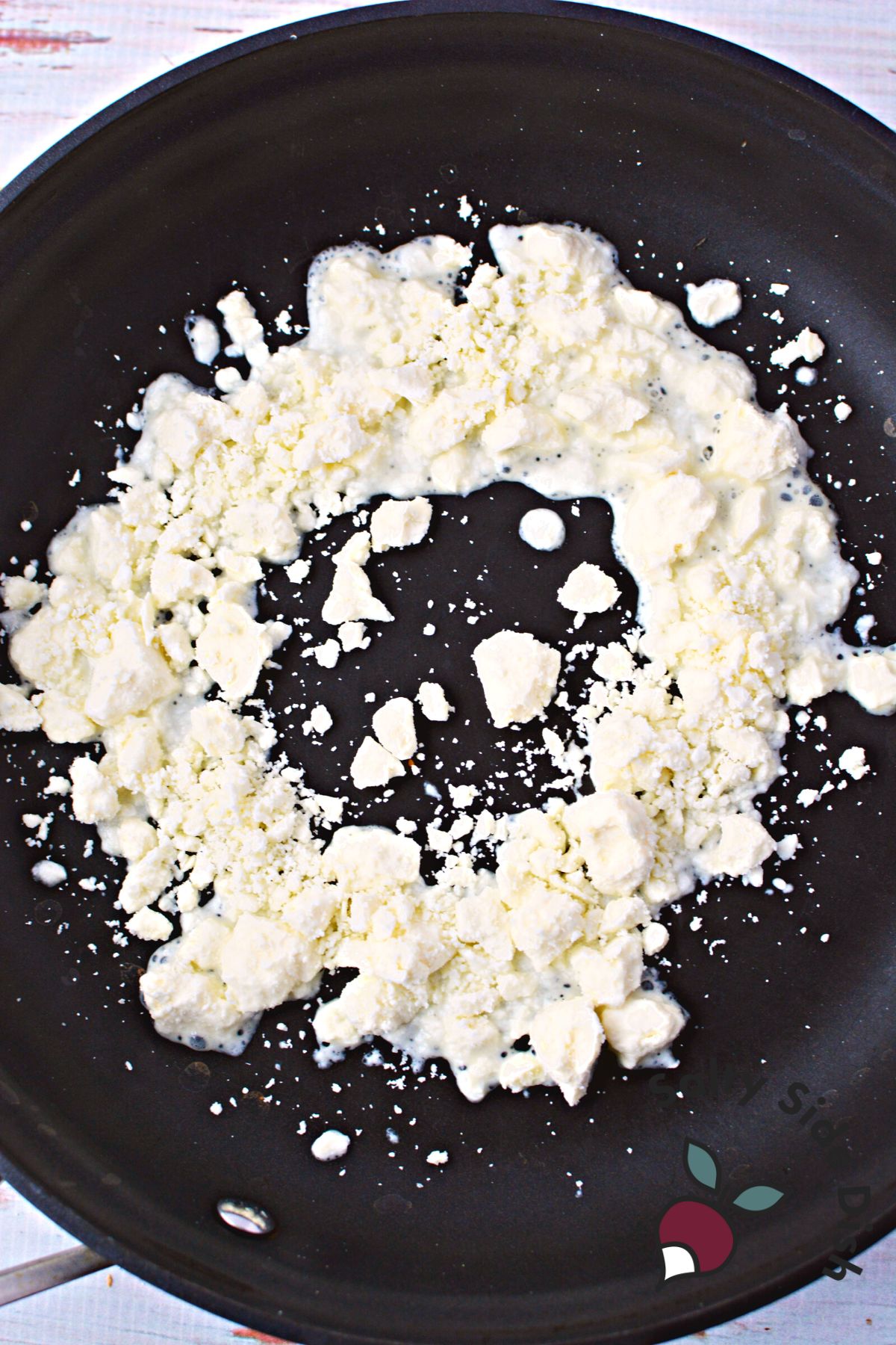 add feta cheese in a ring in the center of a skillet.