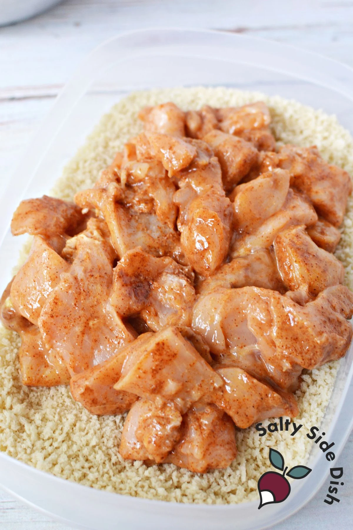 put marinated chicken in panko crumbs tupperware.