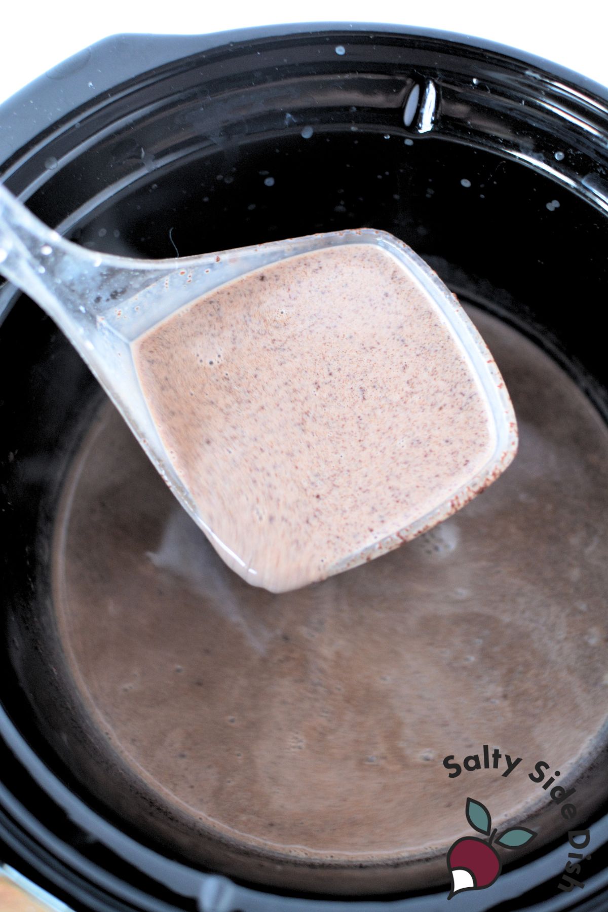 hot chocolate made with real chocolate pieces served in a slow cooker.