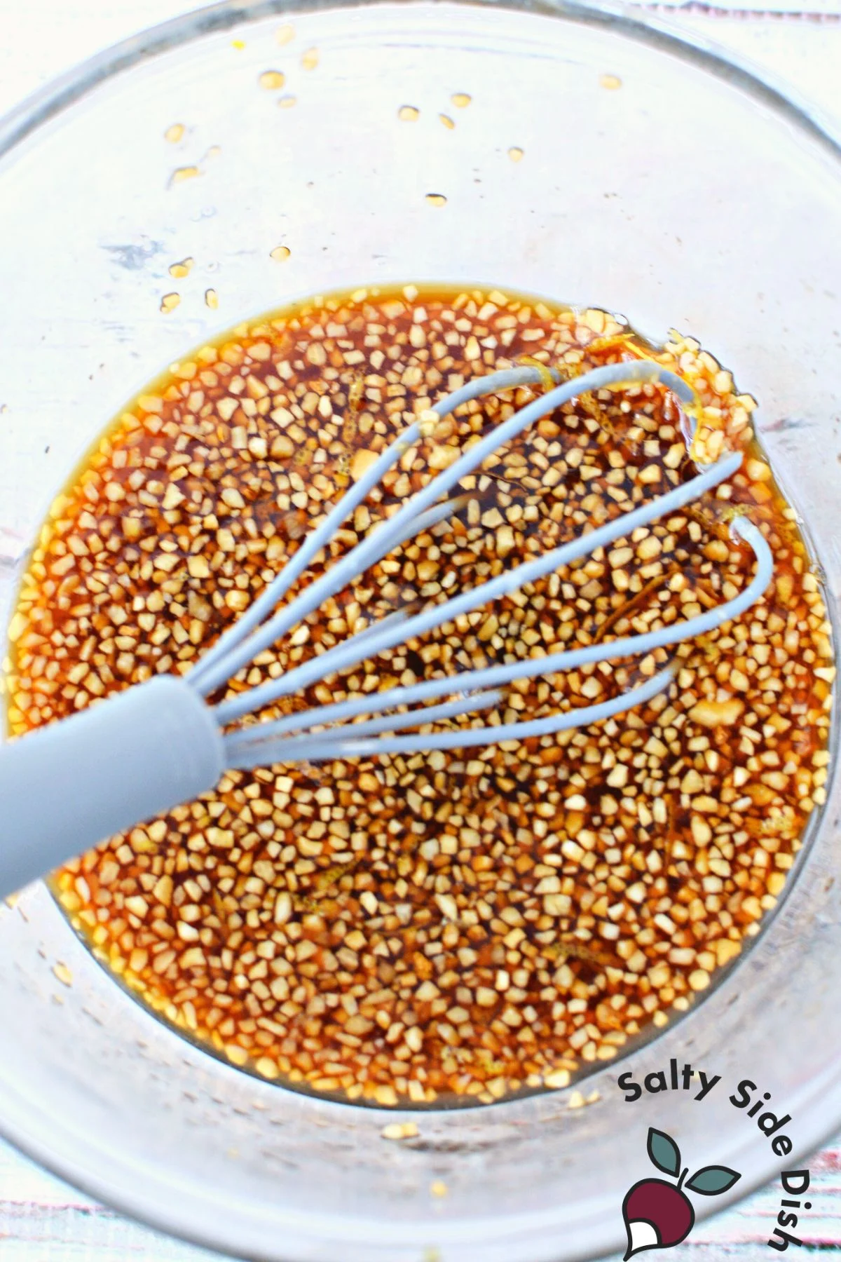 soy and garlic lemon in a sauce being whisked.