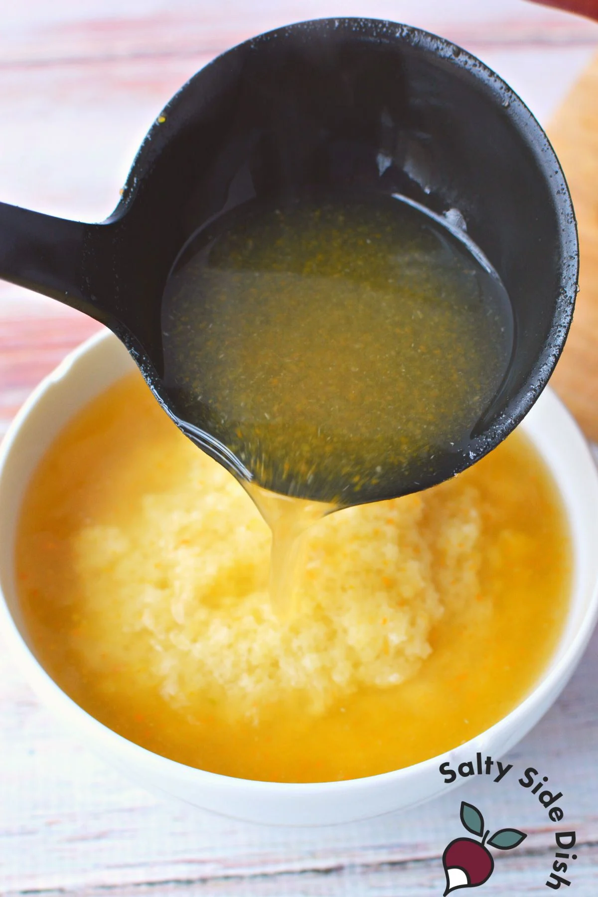 pouring vegetable broth over pastina pasta.