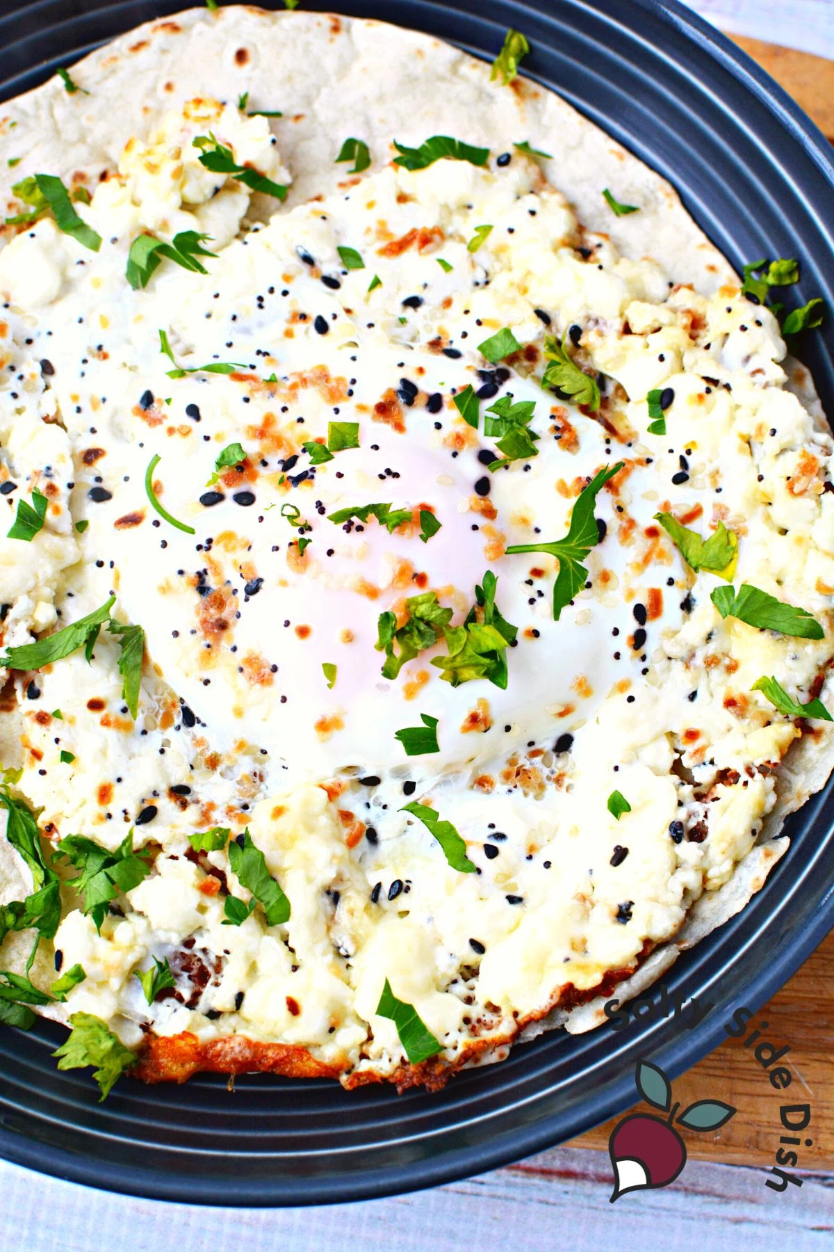 fried eggs with herbs and seasonings sitting in a skillet.